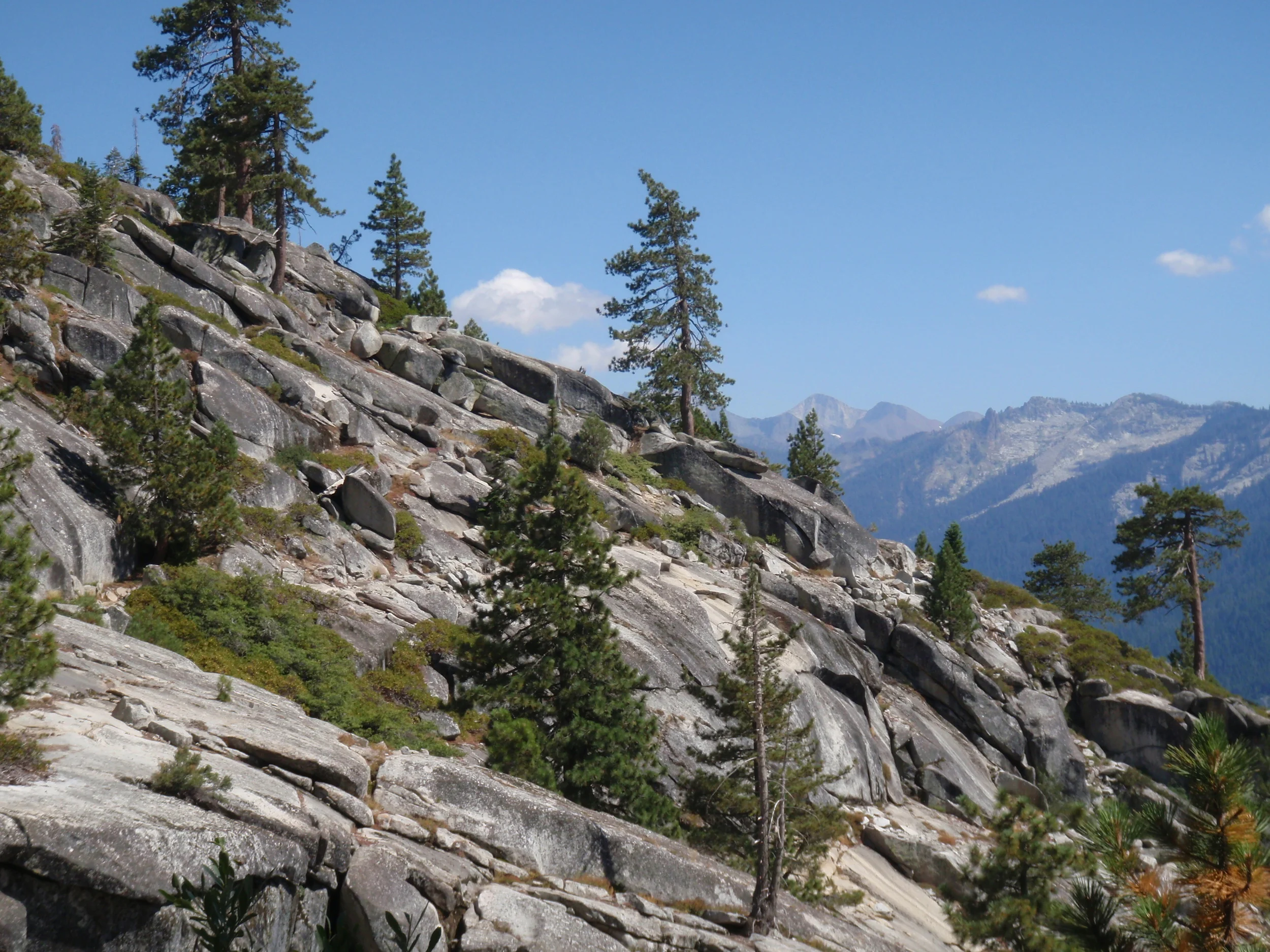 Rocky slope and long view across the Middle Fork Kaweah River from the early miles of the High Sierra Trail 