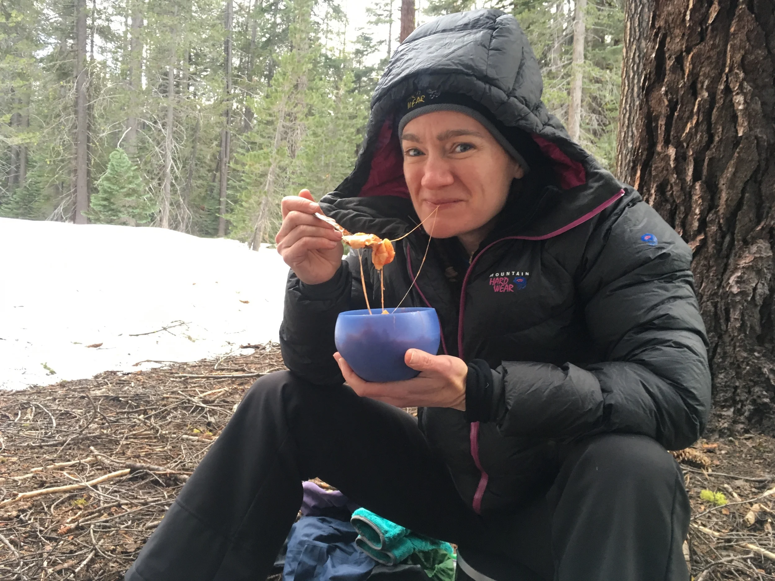 Cheri enjoying some deconstructed lasagna during an April snow camping trip