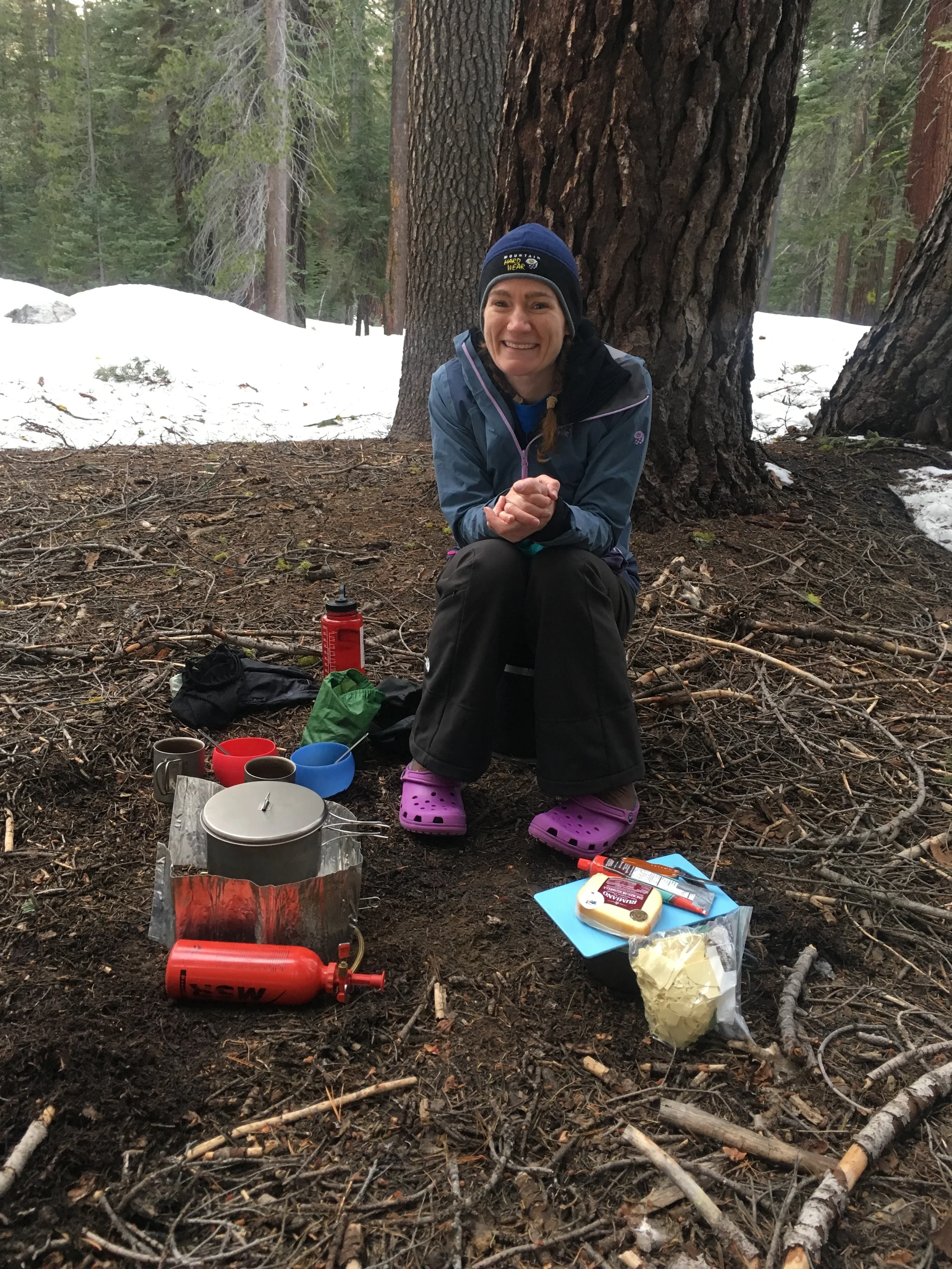 Chilly! Cheri contemplates the cooking area at our campsite before caving in and grabbing her giant down jacket.
