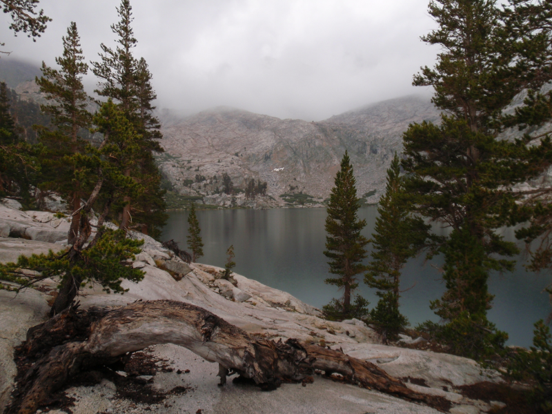 Colby Lake in early evening with clouds obscuring the pass