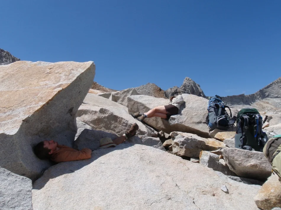 Mike (shade) and Cheri (sun) lounging on boulders at Elizabeth Pass after lunch