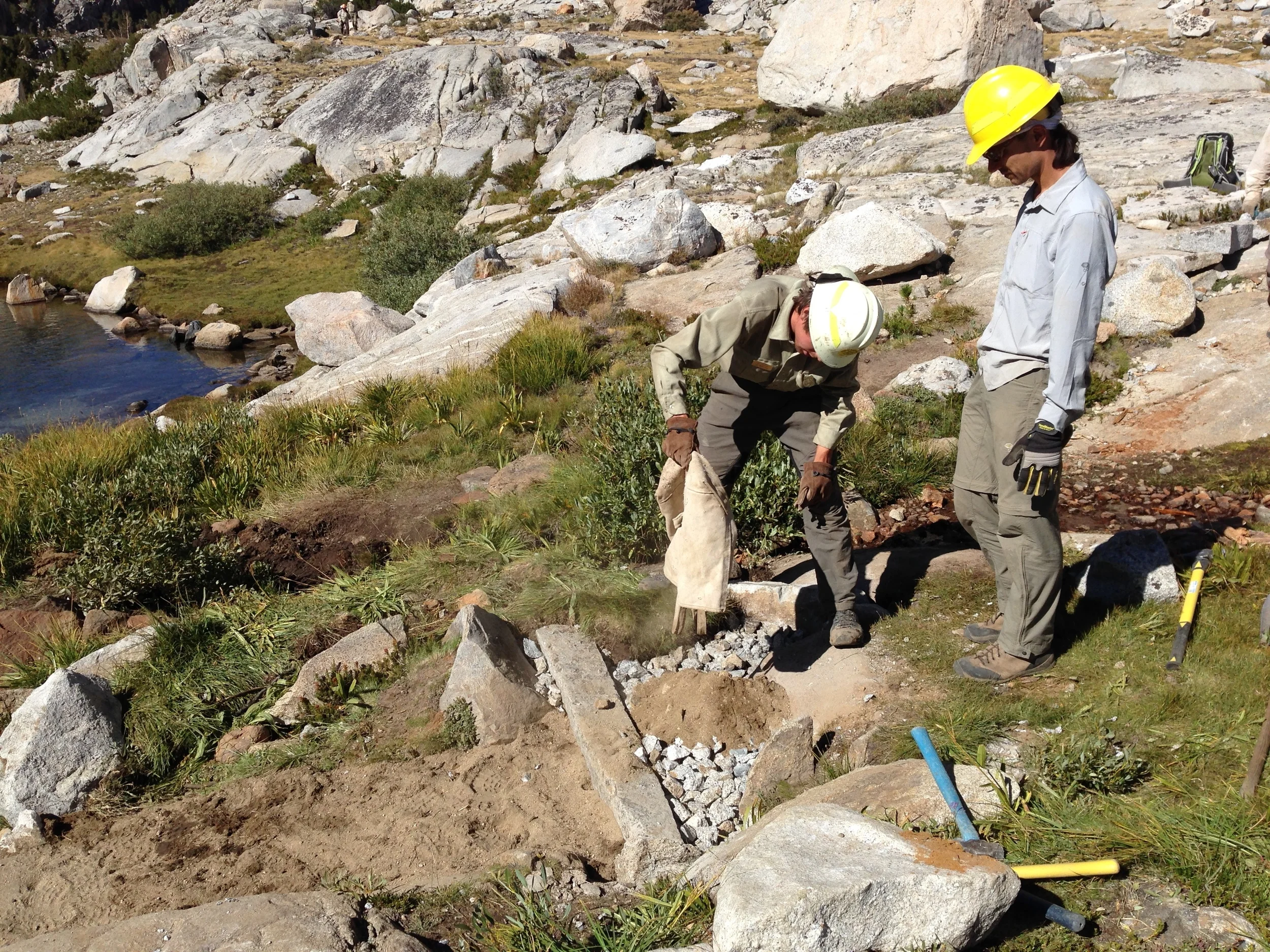 Dirt is taken from far off-trail and carried in canvas bags. Check steps are buried super deep in the ground for stability. Everything is backfilled with crush. Andrew surveys his work.