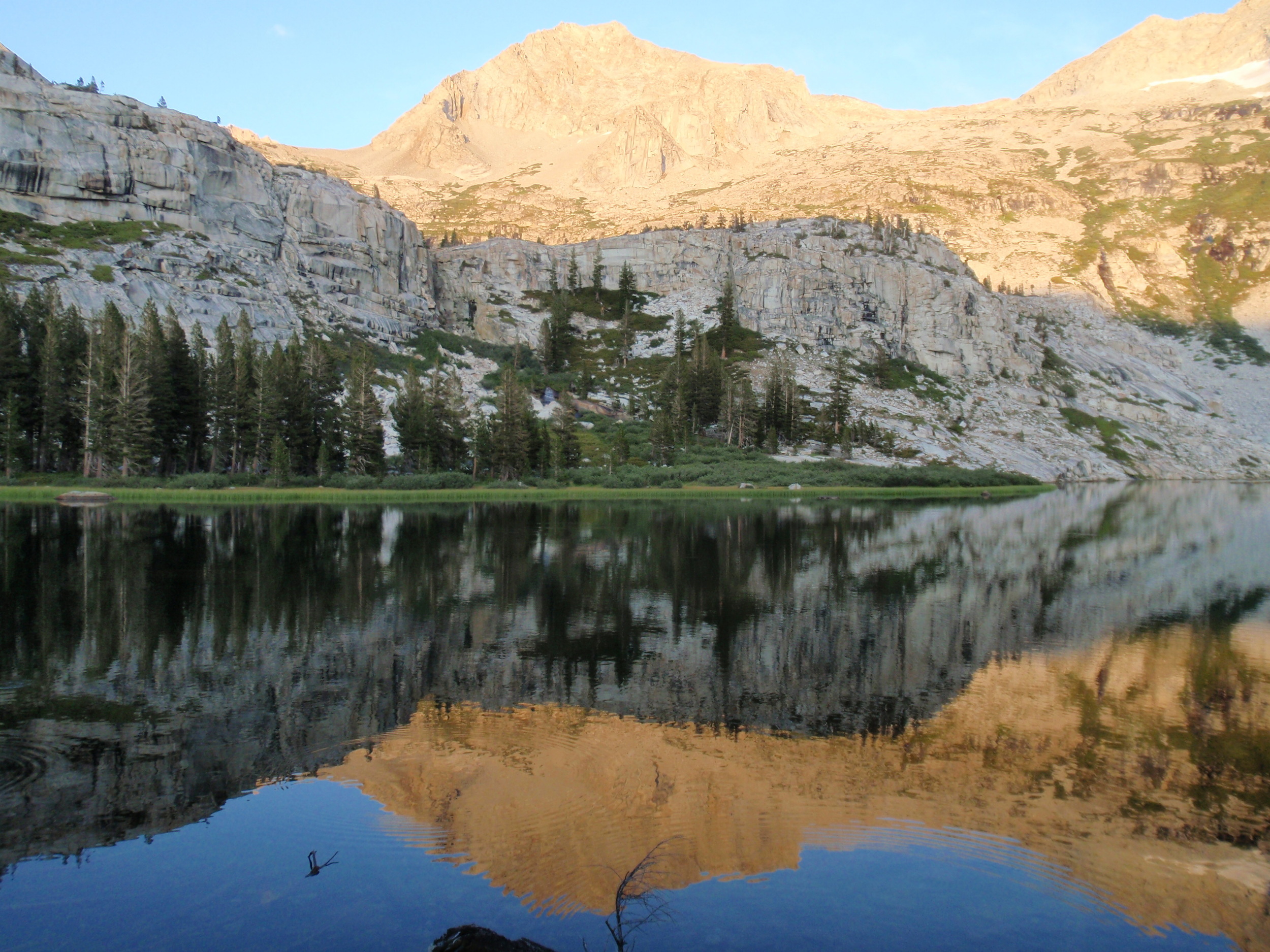 Lion Rock reflected in Tamarack Lake, evening golden hour