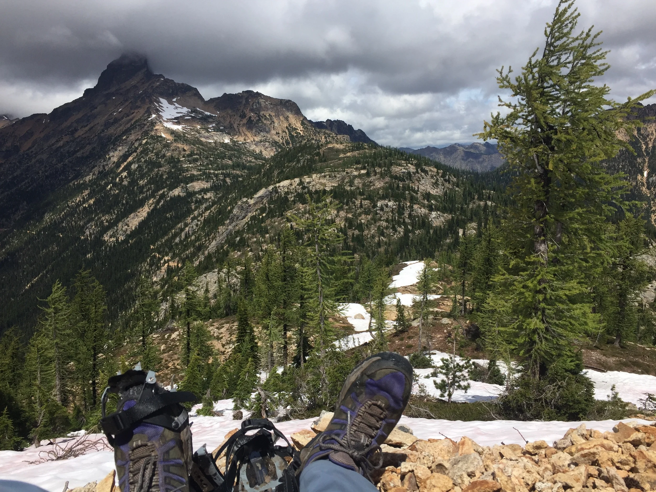 Taking off the crampons after hiking up this steep, narrow, snow-covered ridge from Granite Pass