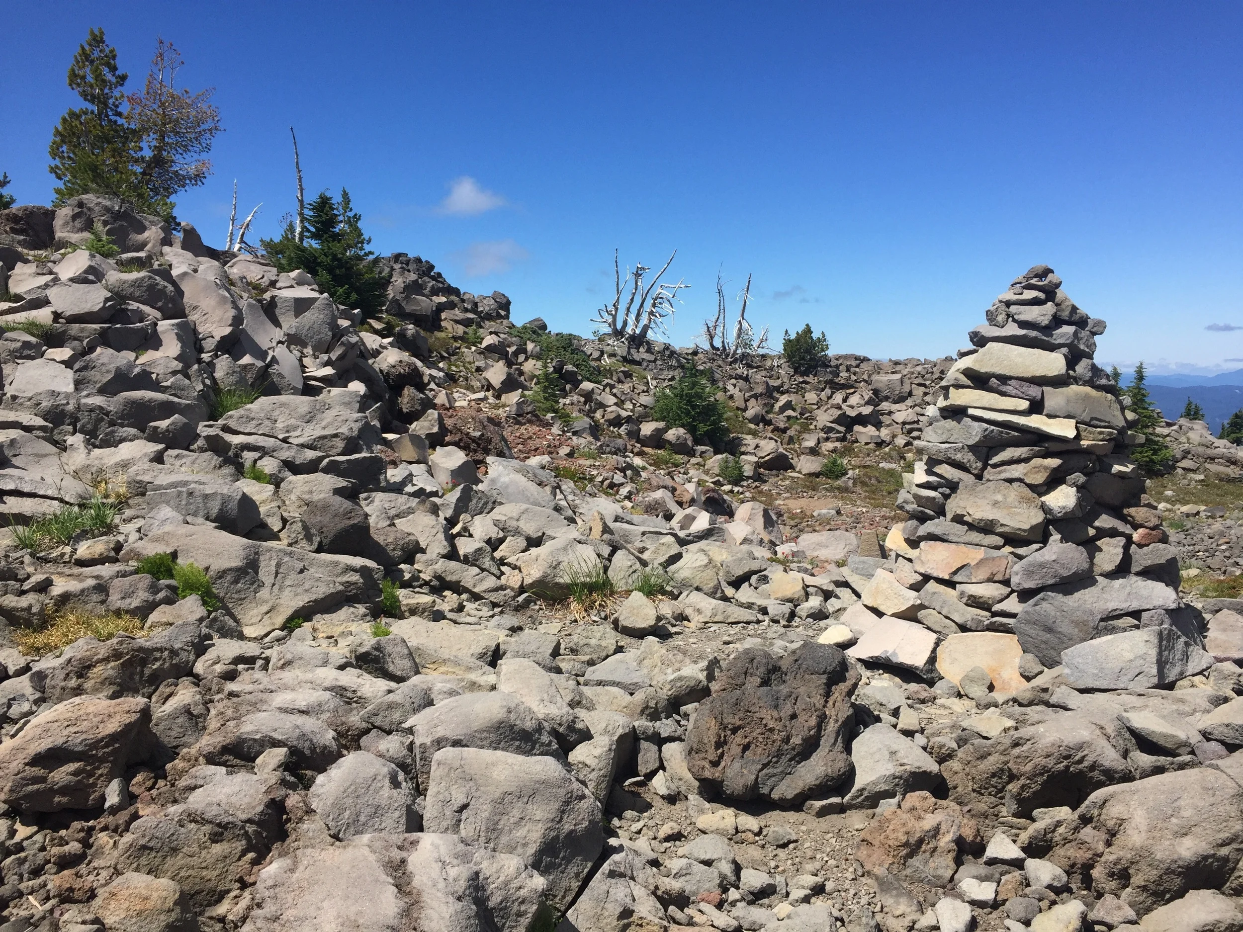 Vegetation gives way to huge rock cairns as we near the top of our climb