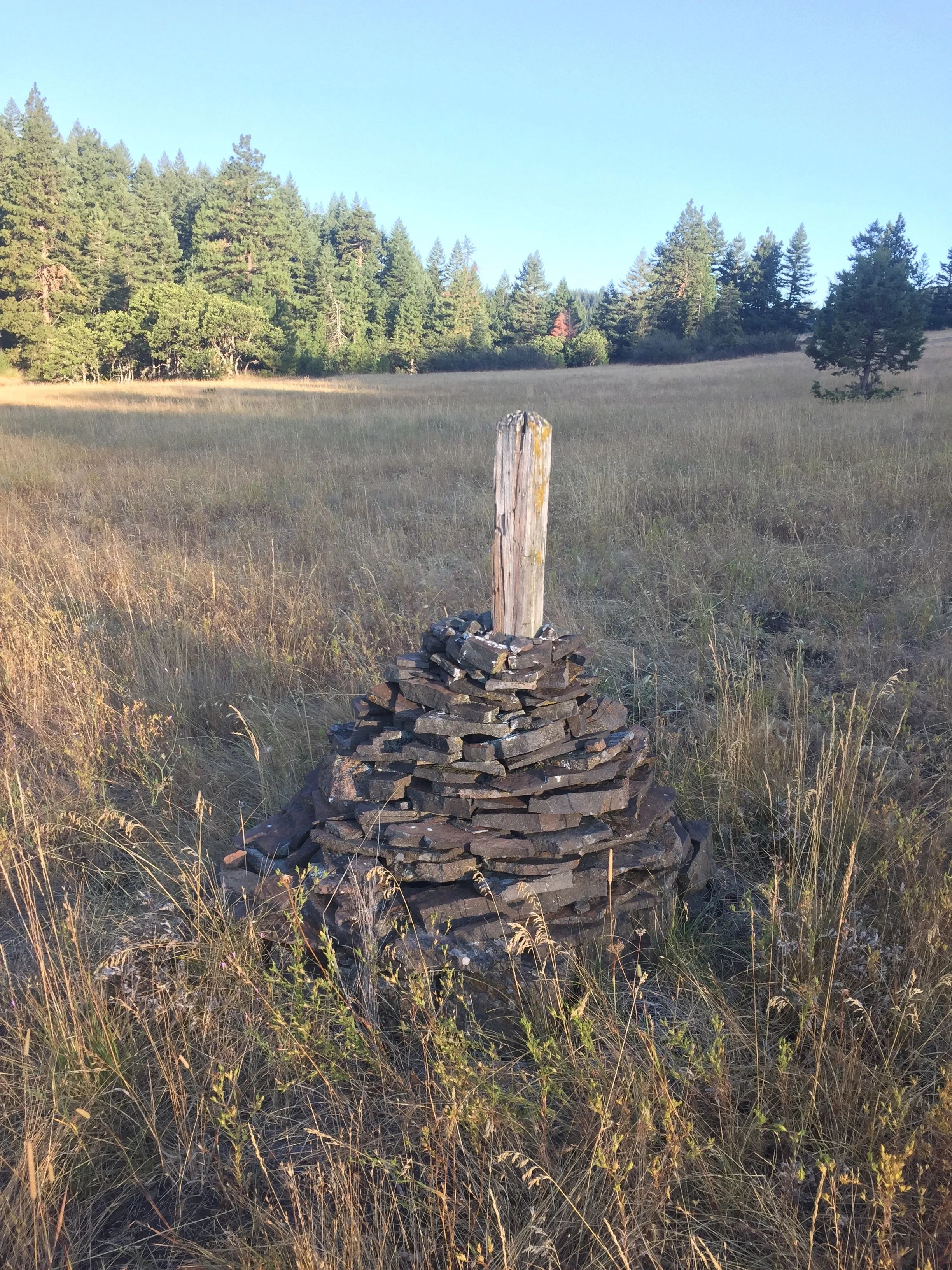 Big rock cairns mark the trail across the meadow below Hyatt Prairie