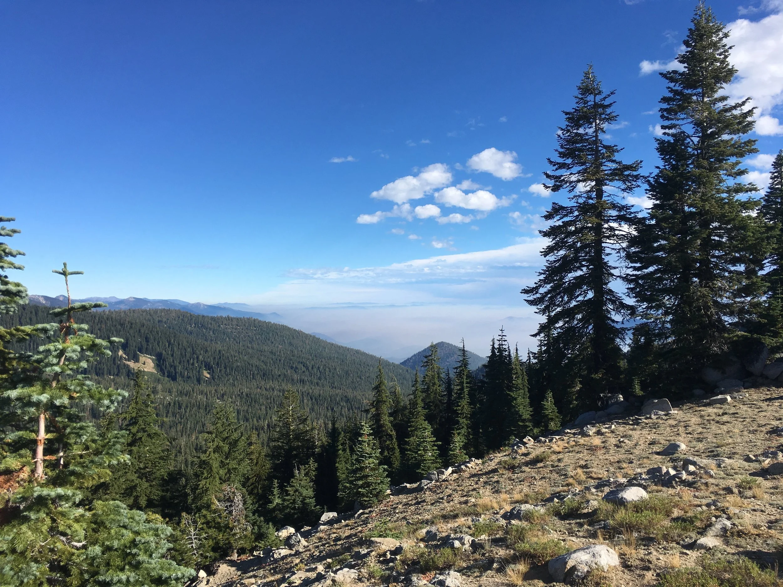 The haze in the valleys below is dispersed smoke from the Gap Fire