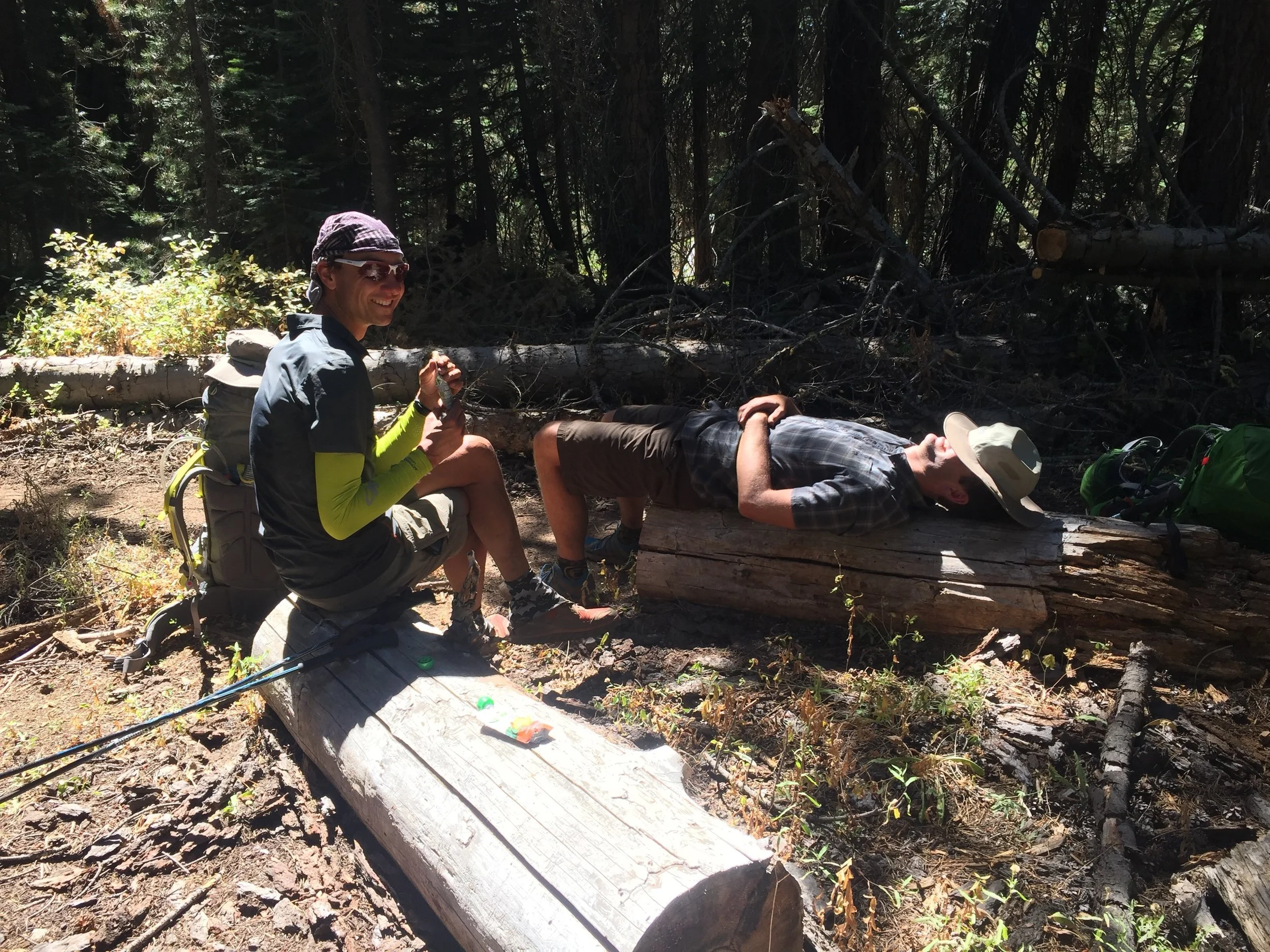 Macro enjoying a snack break while Bryan pretends he's tired near a dry creek 
