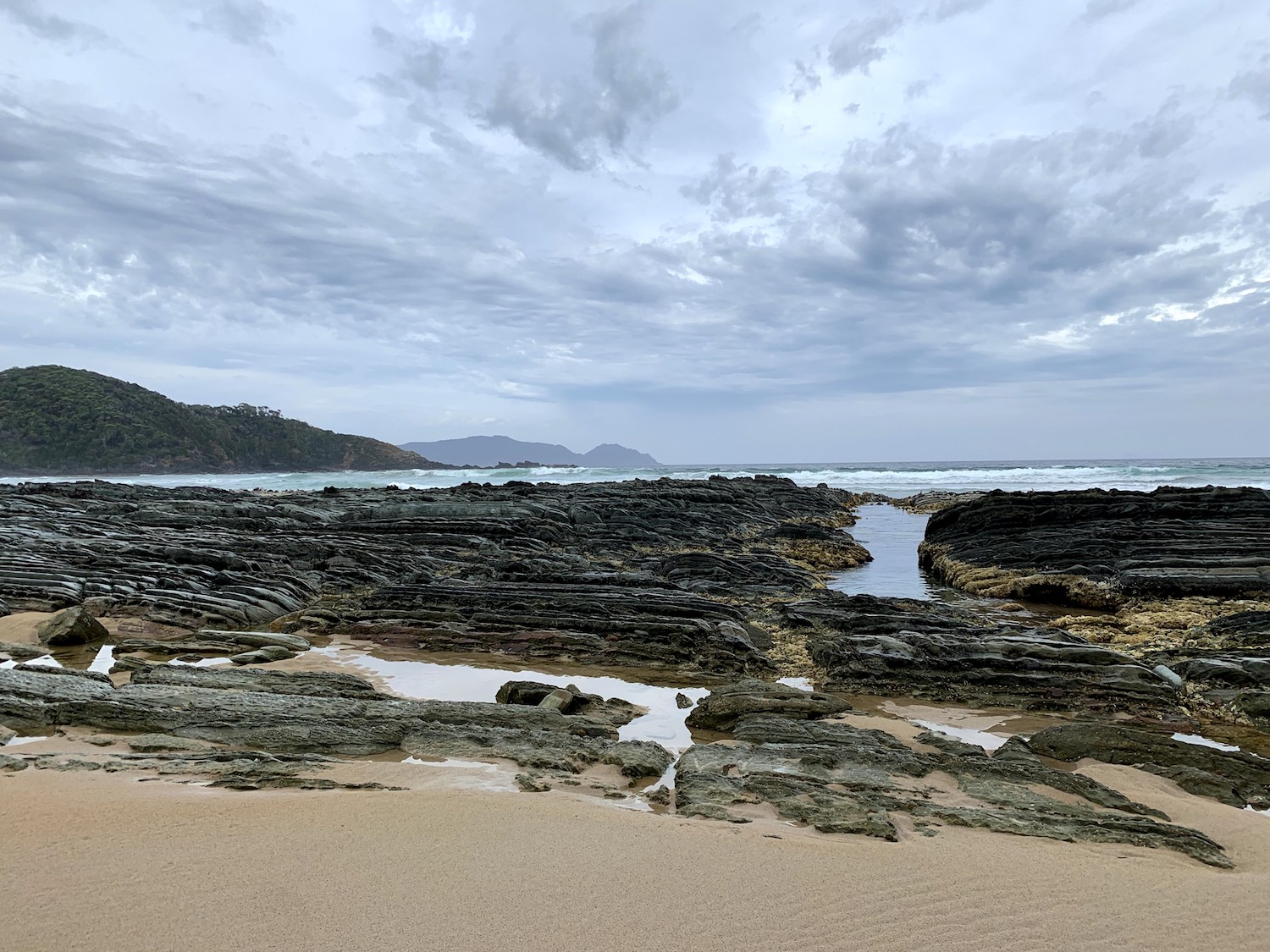 Turua beach ridged rocks dramatic sky.jpg