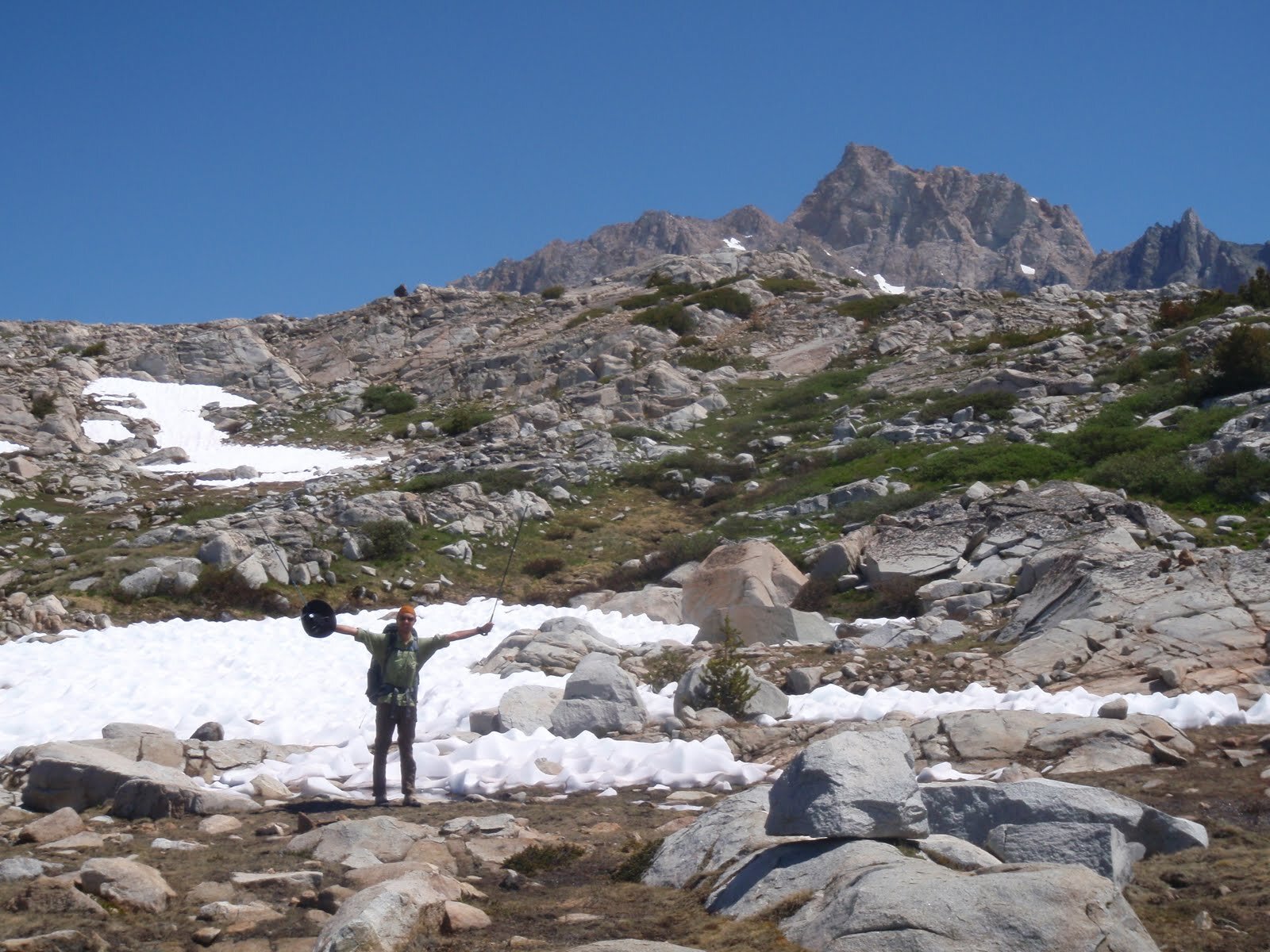 Day 9 A w pack arms outstretched by snowfield below Humphreys Lakes with Mt Humphreys behind.JPG