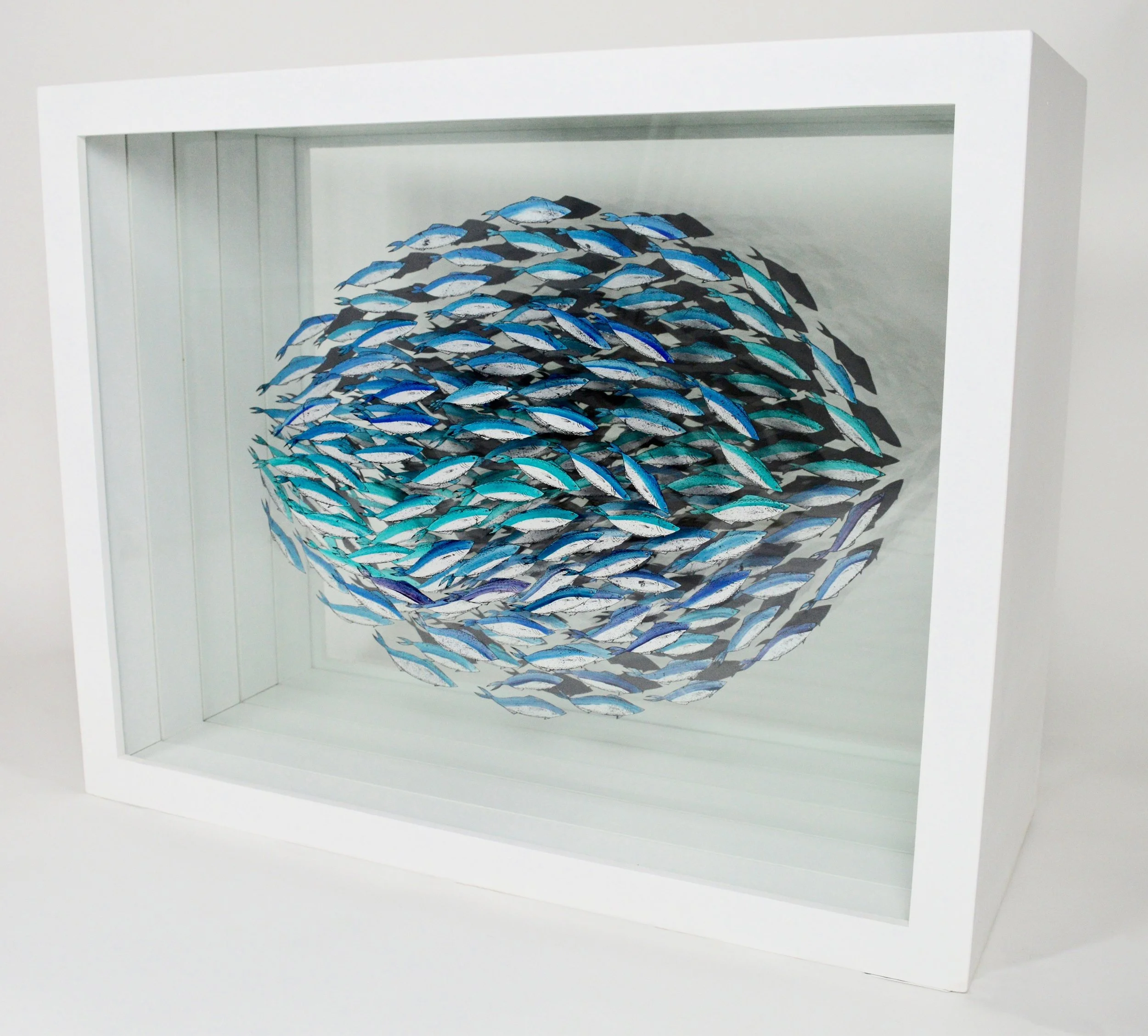 Verre-églomisé artwork of a shoal of blue fish, reverse-painted and gilded on glass