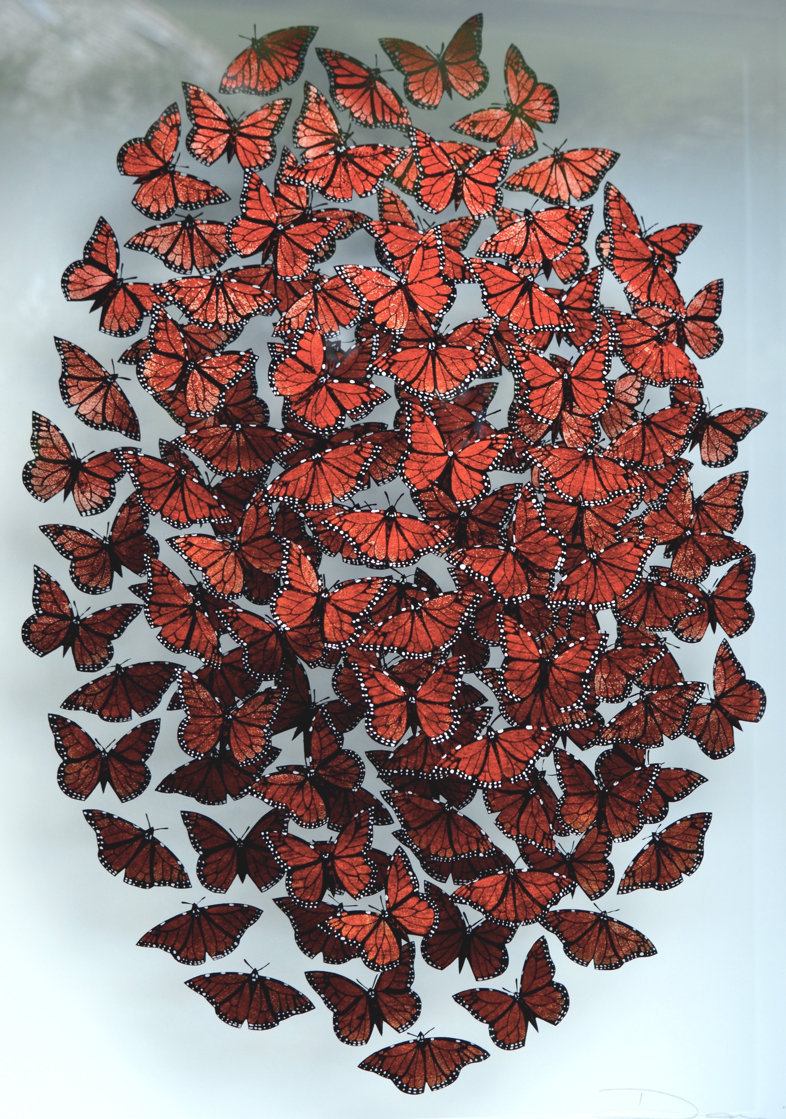Verre-églomisé artwork depicting a swarm of monarch butterflies in flight