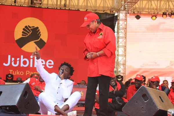 First Lady Margaret Kenyatta watches as singer Bahati performs during the launch of the Jubilee Party on September 10, 2016. The artiste’s act of sitting on the President’s seat as he serenaded the First Lady has drawn more discussion than what the President said at the event. PHOTO | JEFF ANGOTE | NATION MEDIA GROUP