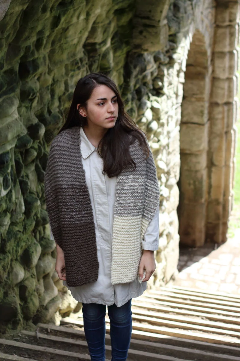 Hopton by Jane Ellison Hopton is easy to knit, with a gradient created by combining two shades held together and alternating them. A little preparation is needed to make the skeins into balls ready to knit, for a smooth and enjoyable project. The result is a fun knit and a stunning, easy to wear wrap! Yarn: Baa Ram Ewe's Dovestone Natural Aran (170m in 100g) Yarn Quantities: 744 yards (680 m) = 1 skein each of Shades 1, 3, 4 and 5 Needles: 10mm straights Notions: Kitchen scales (to divide the balls during the preparation for knitting!) Size: One size = 35cm x 160cm (13.75 x 63")