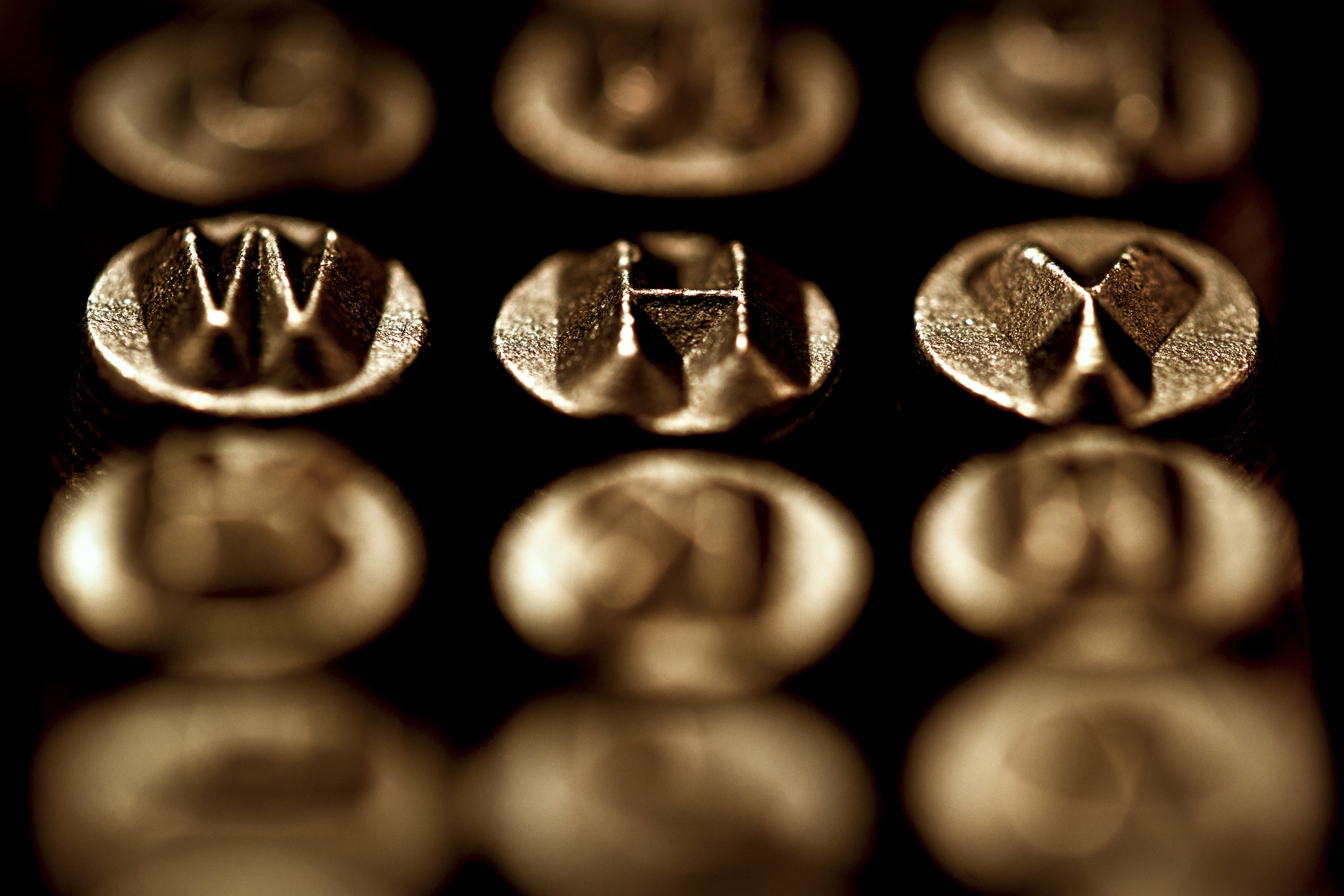 Shallow depth of field puts the focus where the photographer wants it. In this case, it highlights the letters spelling the word 'Why' while the other letters in the set are out of focus.