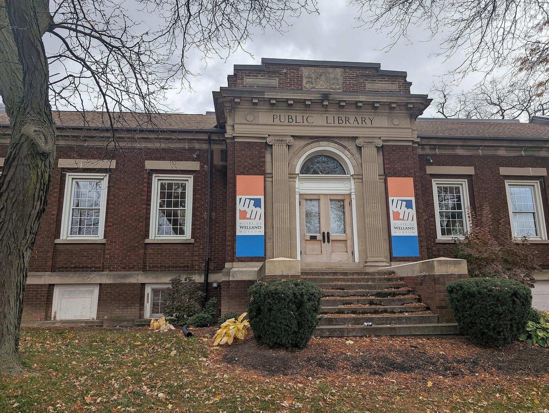 The brick front of the Welland Museum, a former Carnegie public library building with stone steps, in Welland.