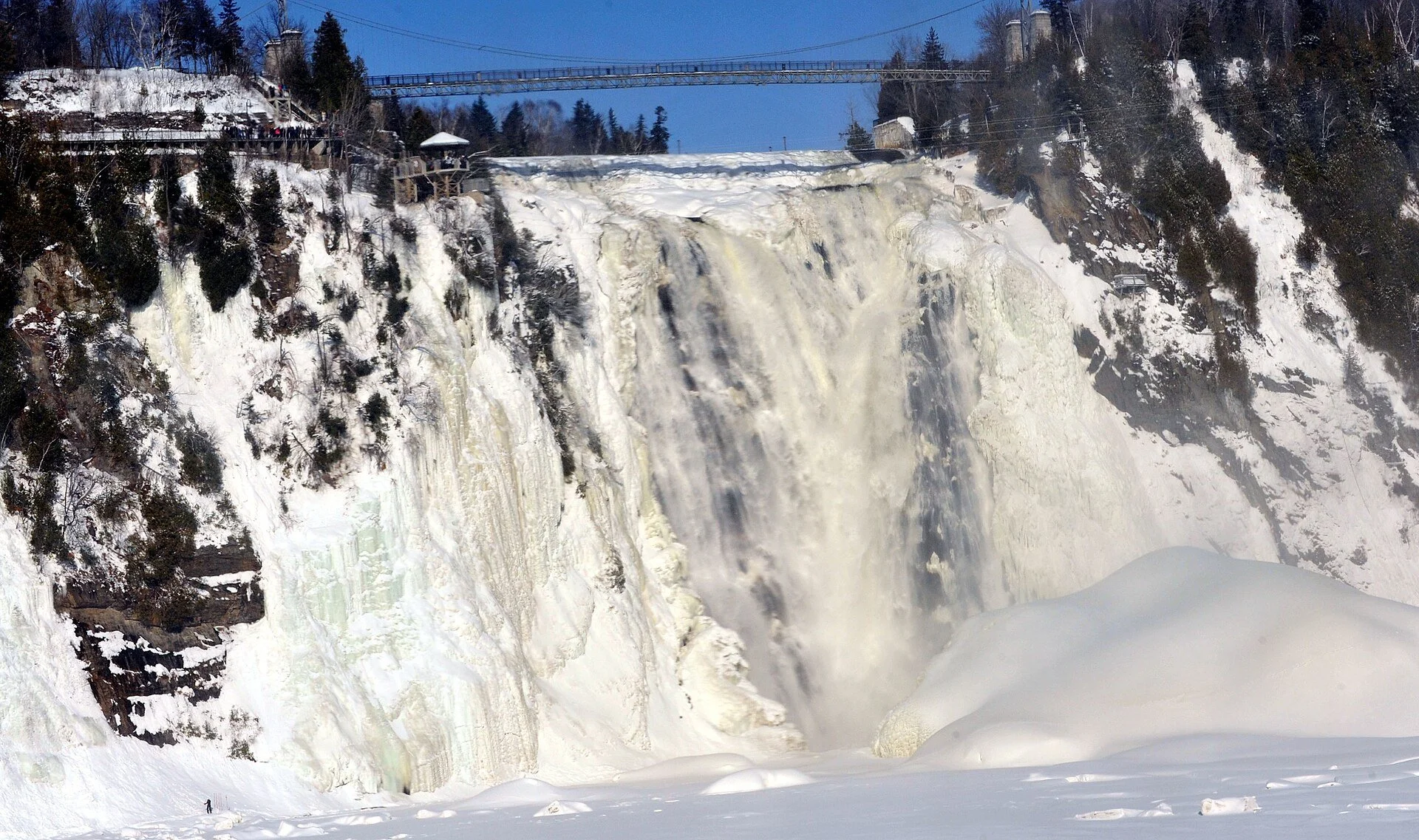 Montmorency Falls surrounded by ice and snow in winter.