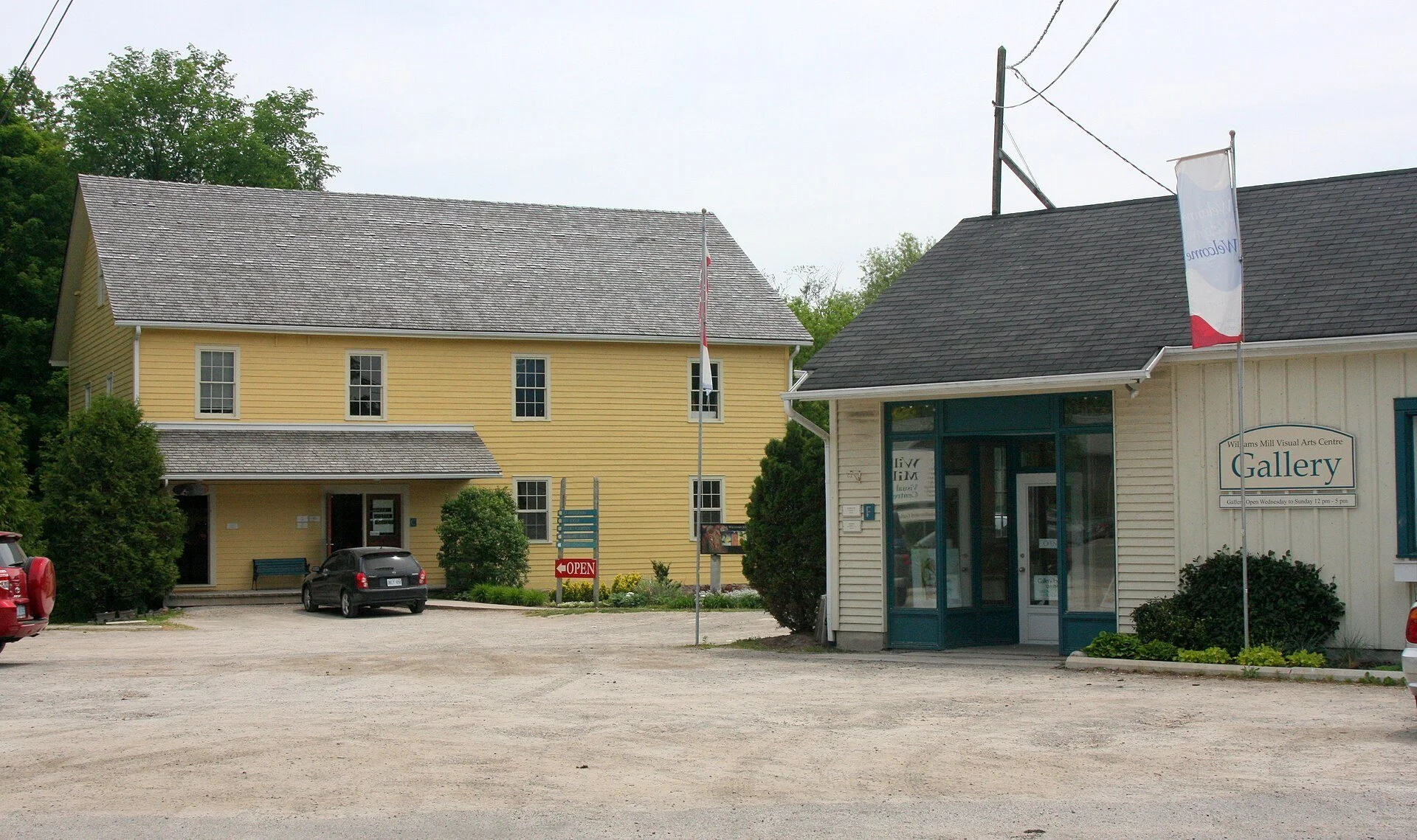 The yellow Williams Mill arts centre buildings and gallery storefront on Main Street in Glen Williams, Halton Hills.