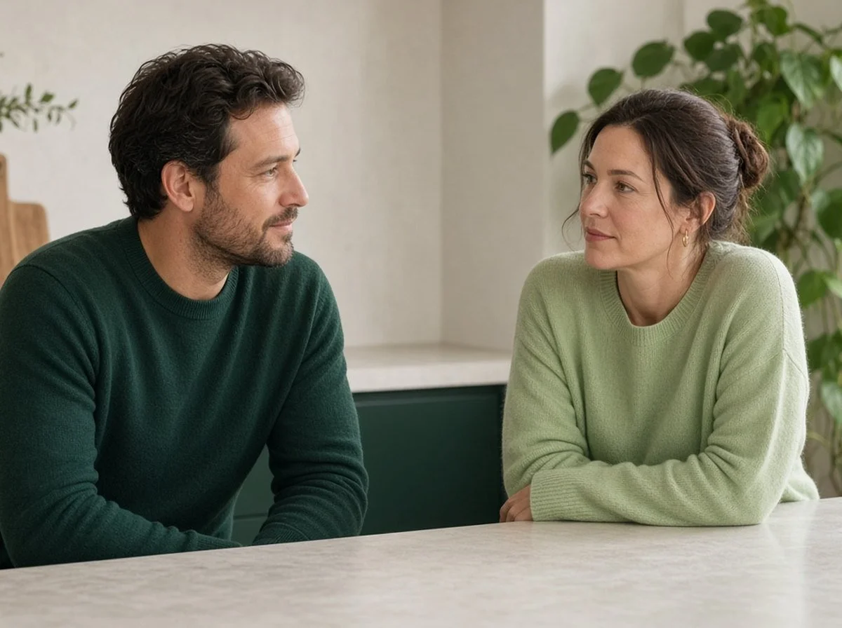 Two co-parents talking at a kitchen counter