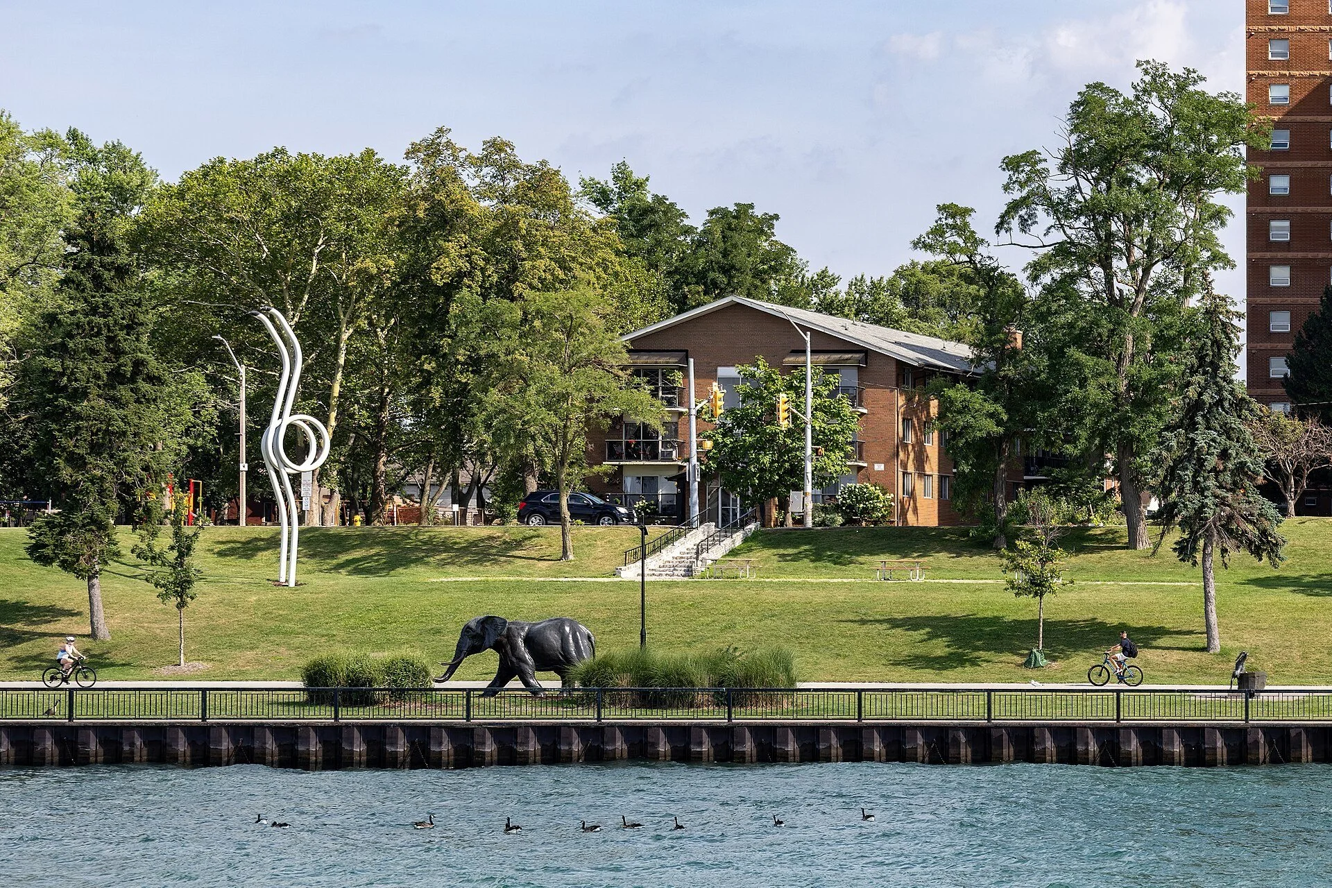 Sculptures on the riverside lawns of The Windsor Sculpture Park, including a bronze elephant, seen from the Detroit River.