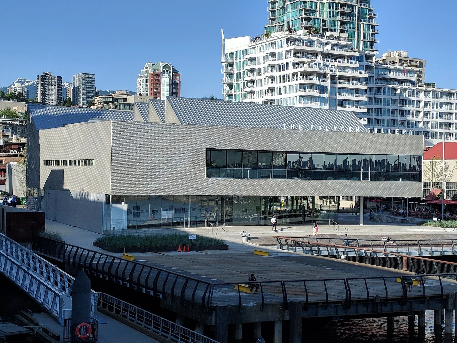 The Polygon Gallery's sawtooth-roofed building at the foot of Lonsdale in North Vancouver, under a clear blue sky.