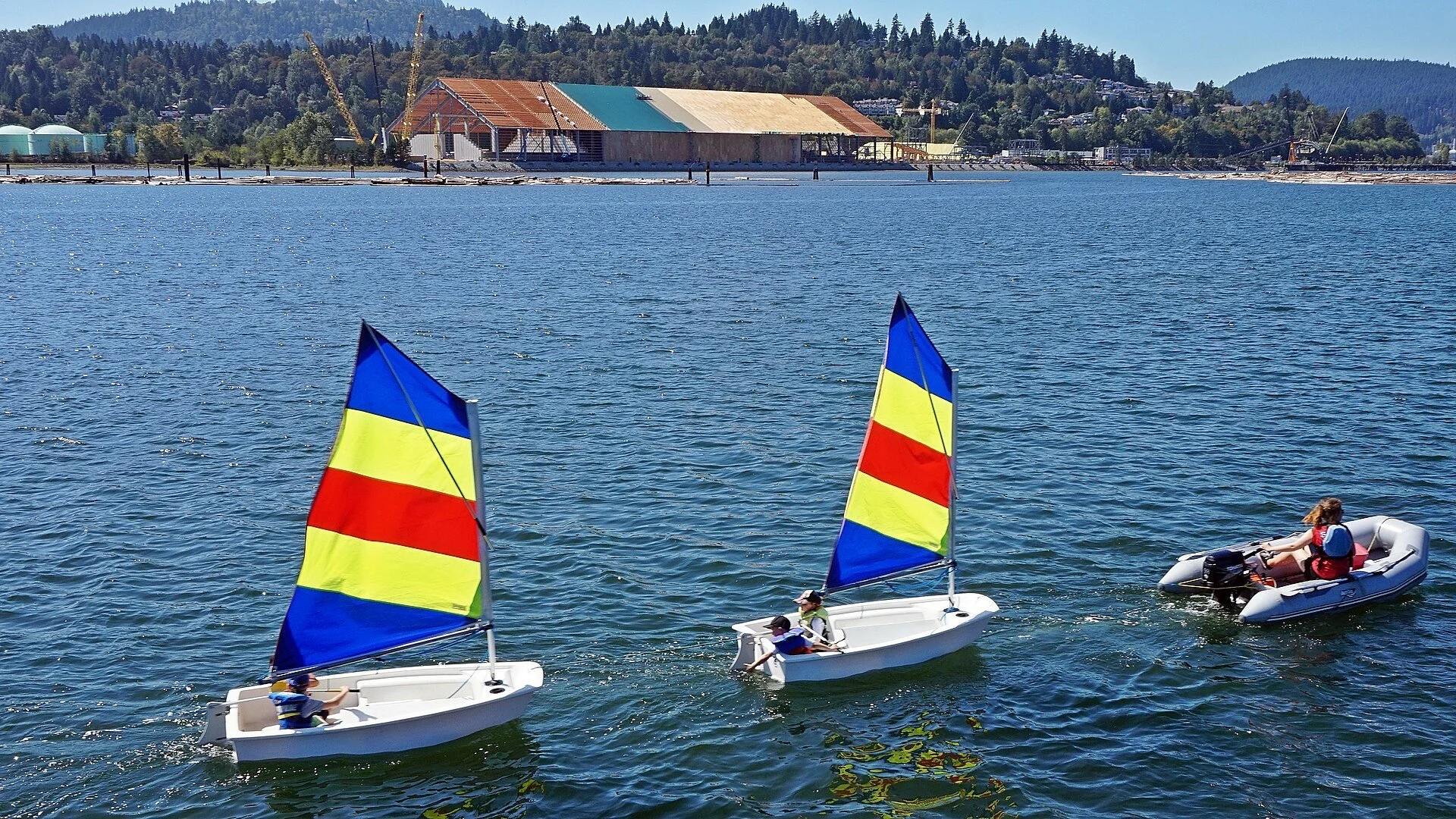 Small colourful sailboats on Burrard Inlet in Port Moody, British Columbia.