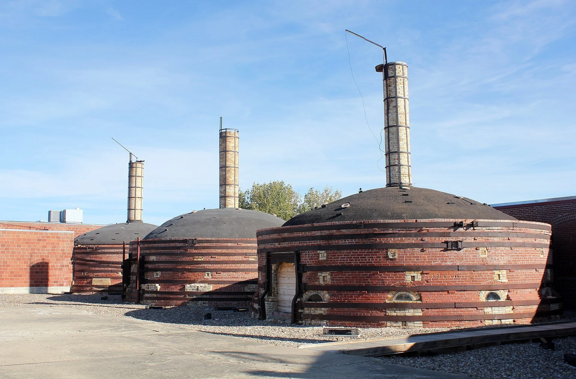 Round brick beehive kilns with tall chimneys at Medalta Potteries in the Historic Clay District of Medicine Hat.