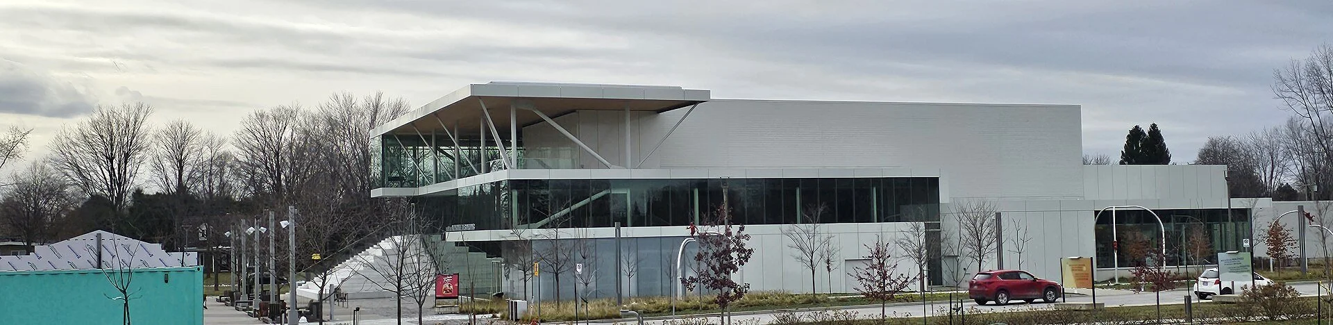 The modern glass and white facade of the Théâtre Alphonse-Desjardins at the Espace Culturel in Repentigny, Quebec.