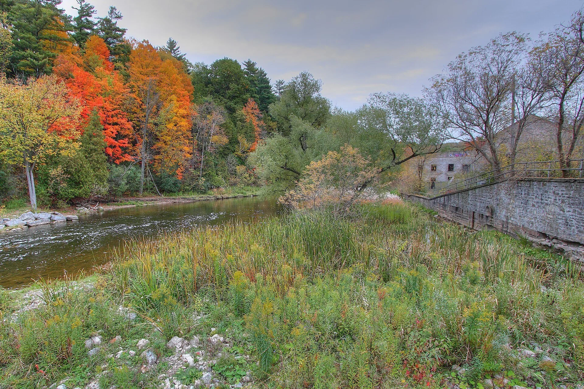 The Credit River and autumn trees beside the old Barber Paper Mill in Georgetown, Ontario.