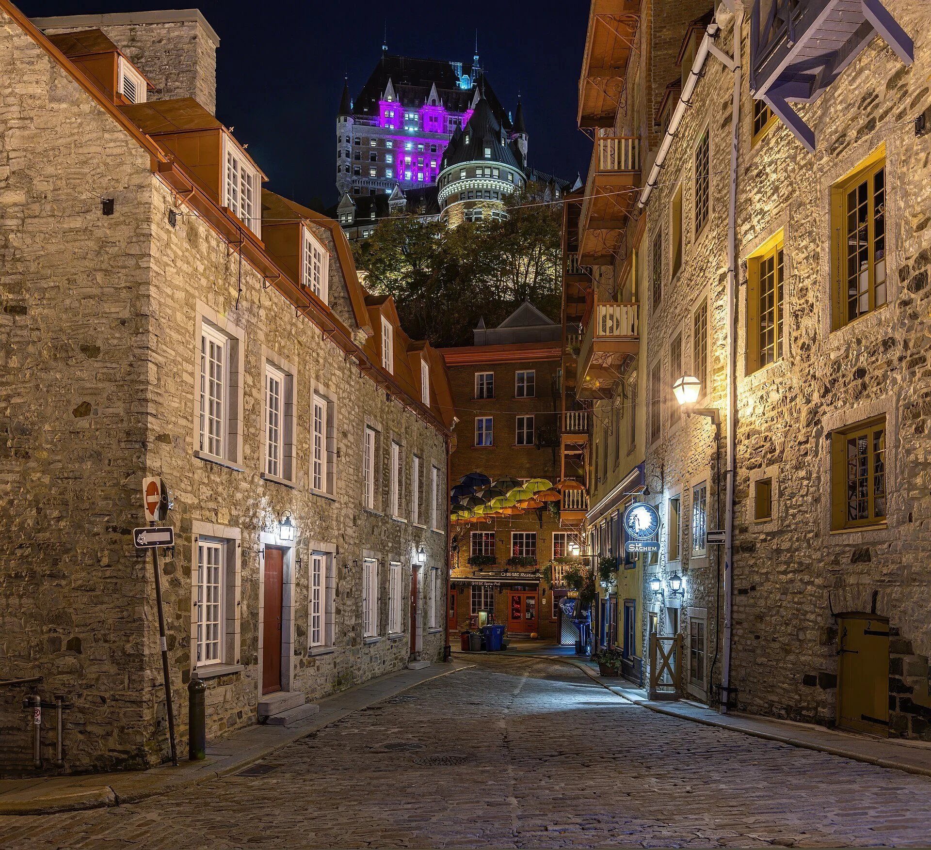 A lamplit street in Quartier Petit Champlain at night.