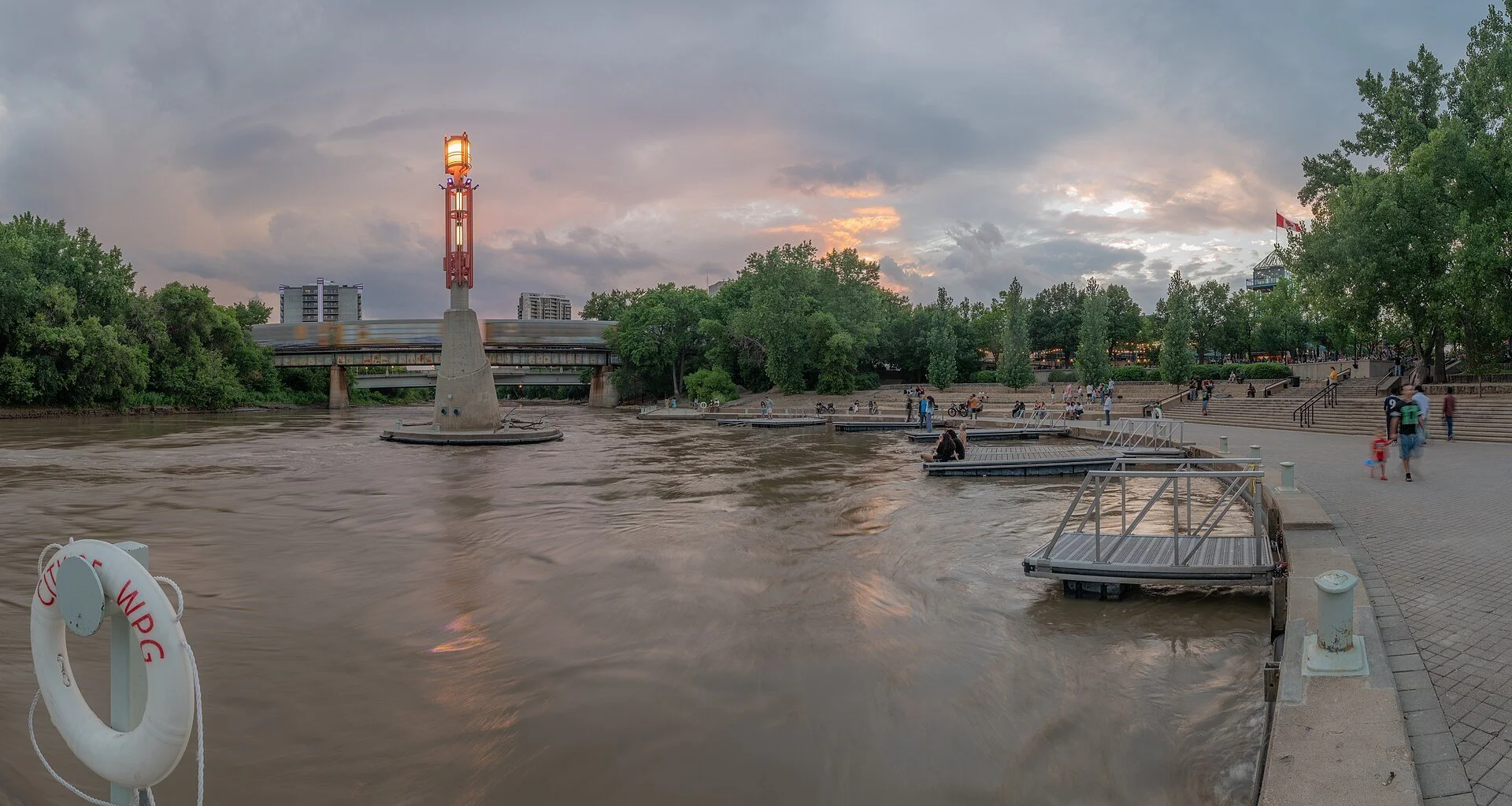 The Forks in Winnipeg at dusk, where the Red and Assiniboine rivers meet.