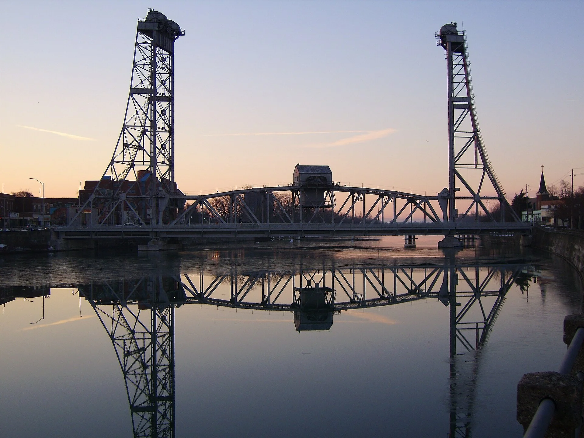 The Main Street lift bridge over the Welland Recreational Waterway, reflected in calm water at dusk.