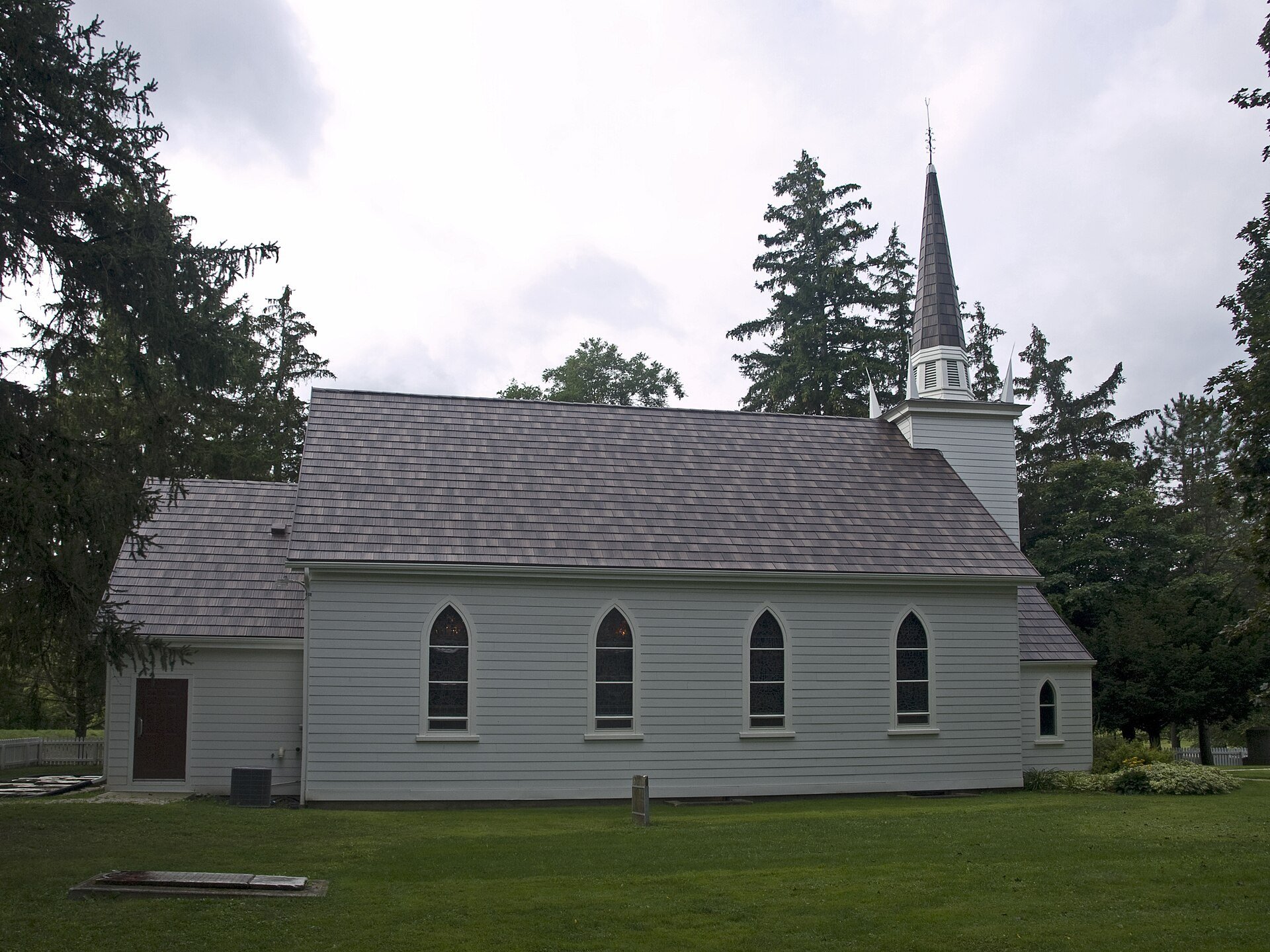 The white wooden Mohawk Chapel in Brantford, seen from the side.