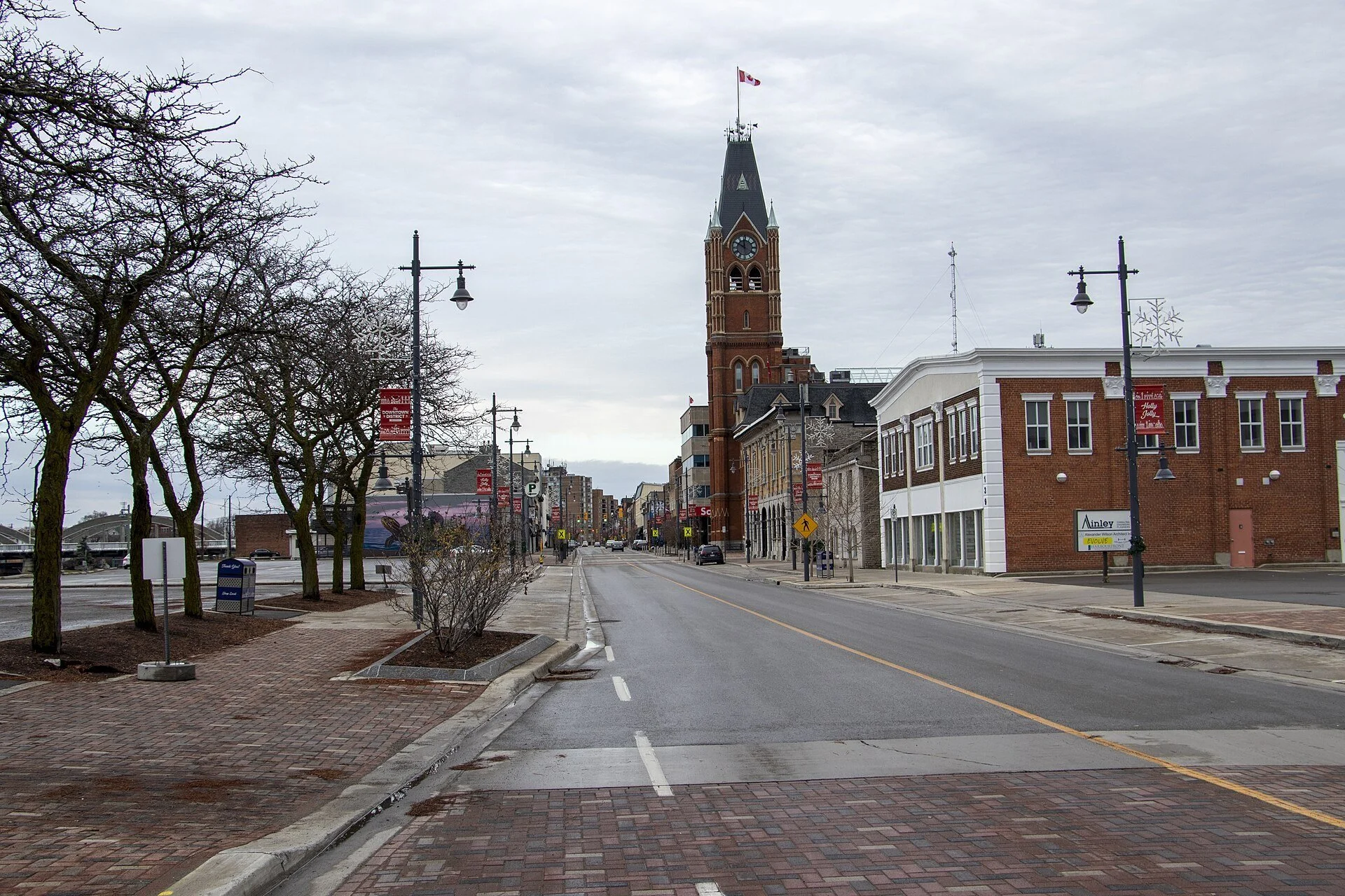Front Street in downtown Belleville with brick storefronts, bare trees and the Belleville City Hall clock tower.