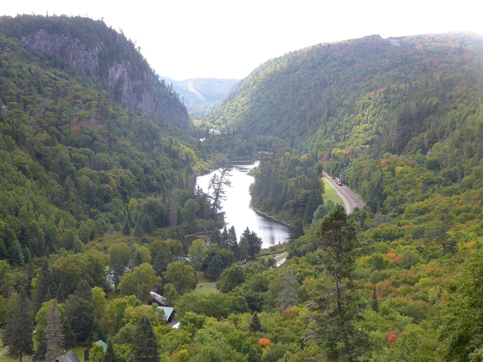 The forested walls of Agawa Canyon north of Sault Ste. Marie, Ontario, with the tour train's rail line and the Agawa River far below.