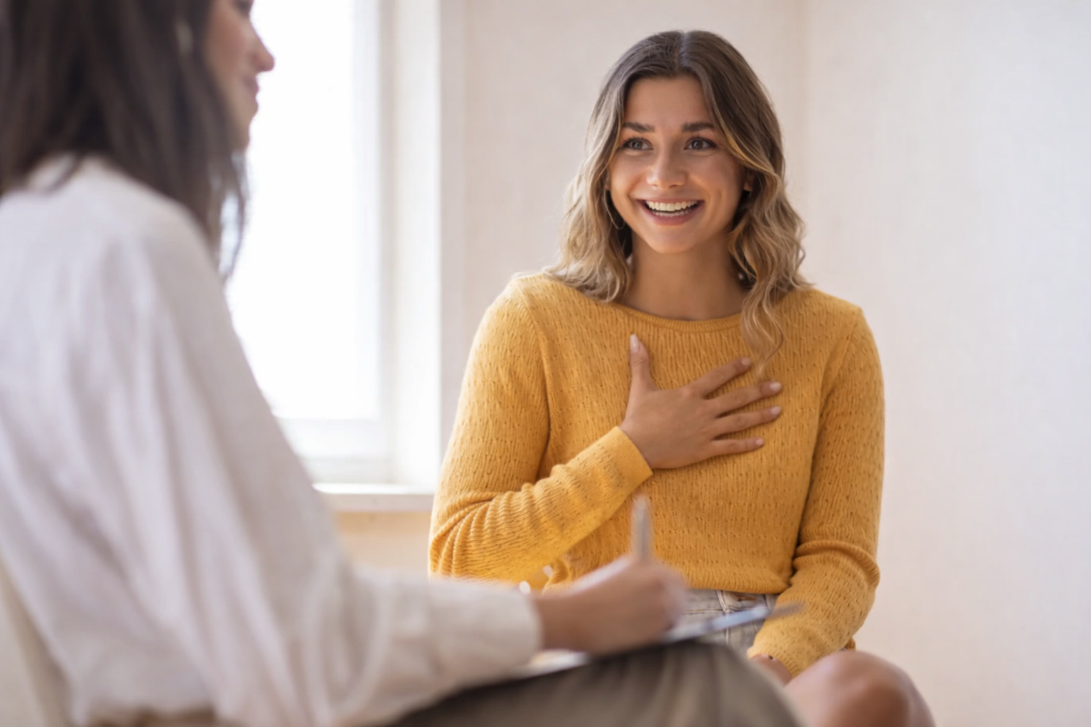 female psychologist speaking with a happy content client about their assessment findings