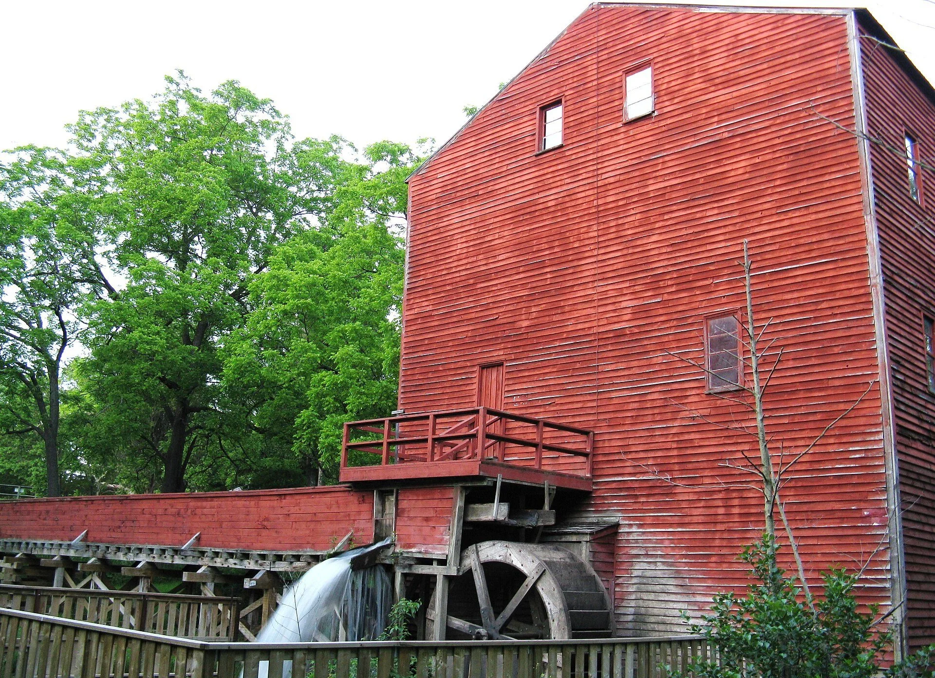 The red wooden Backhouse Grist Mill and its waterwheel at Backus Heritage Conservation Area near Port Rowan, Norfolk County.