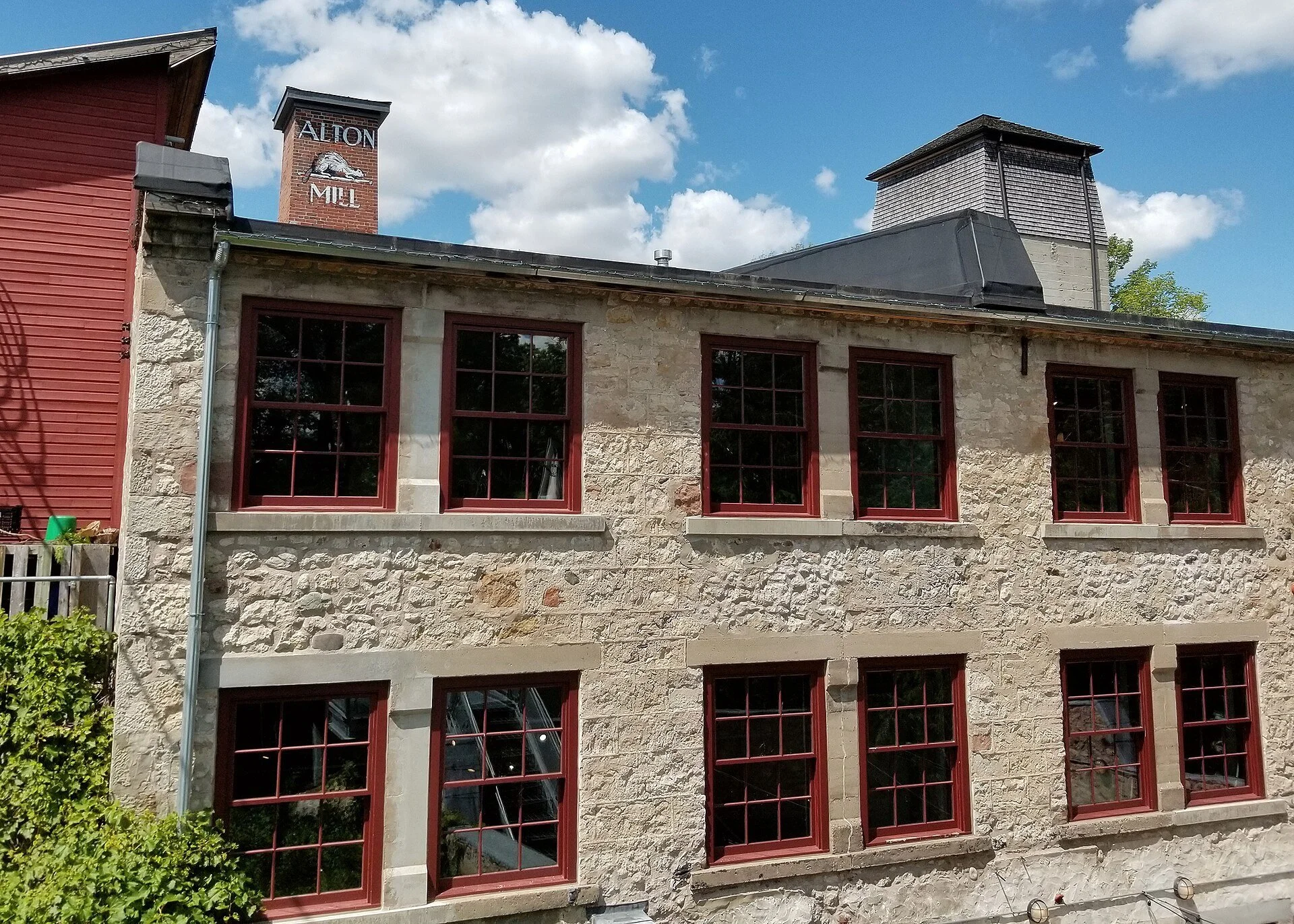 The stone Alton Mill arts centre beside its millpond in the village of Alton, Caledon, Ontario.