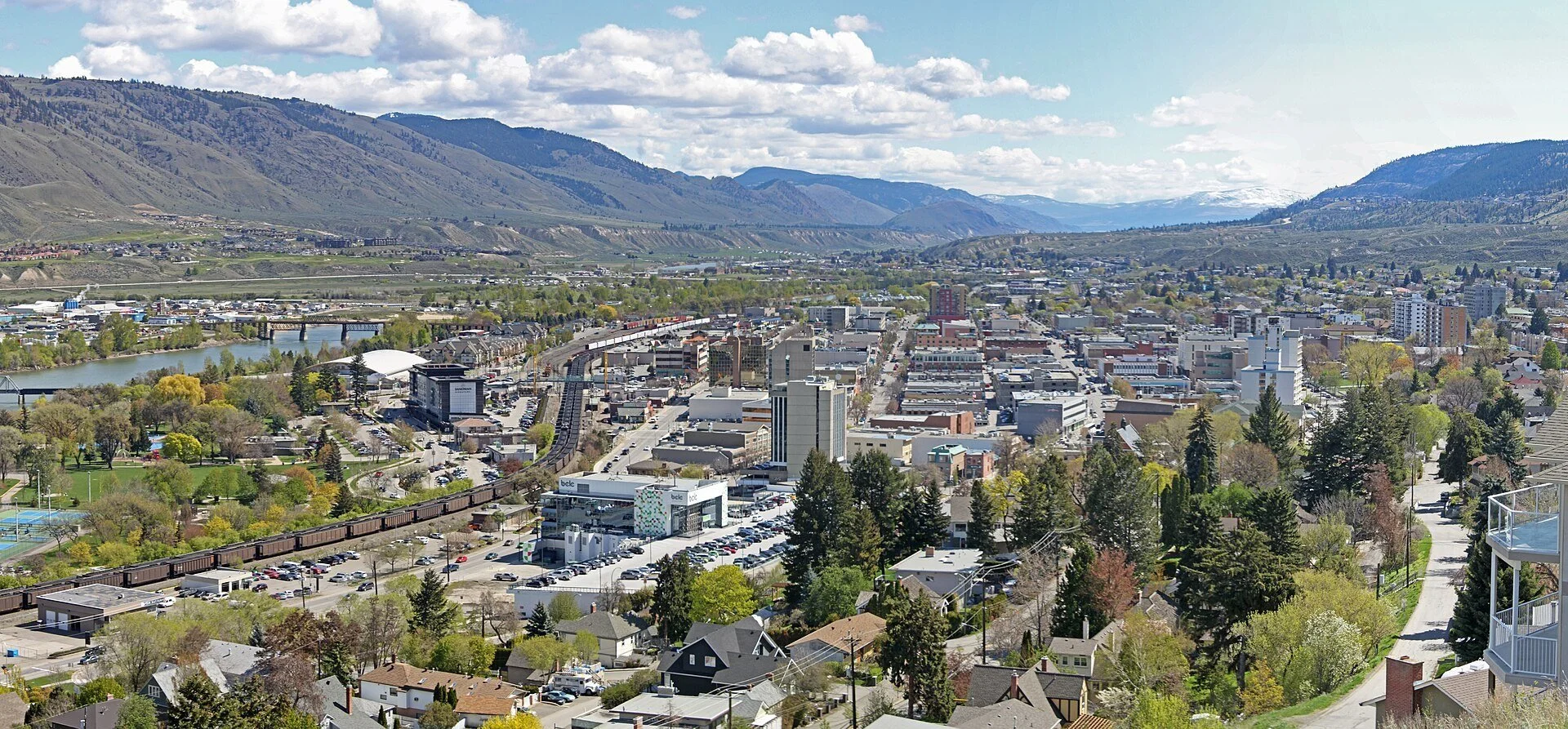 Downtown Kamloops and the Thompson River below dry, rolling hills.