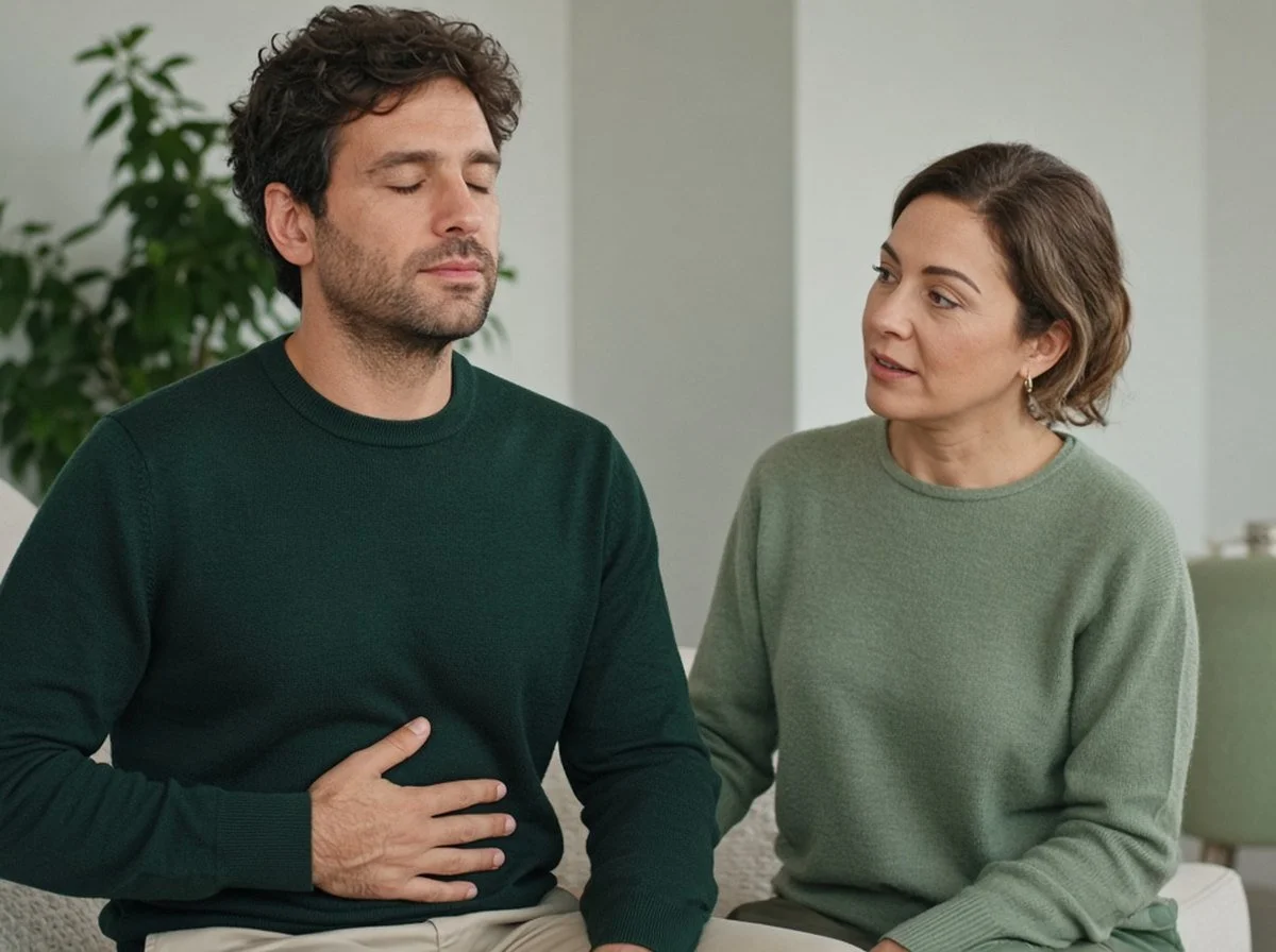 Man practising slow breathing with a female therapist