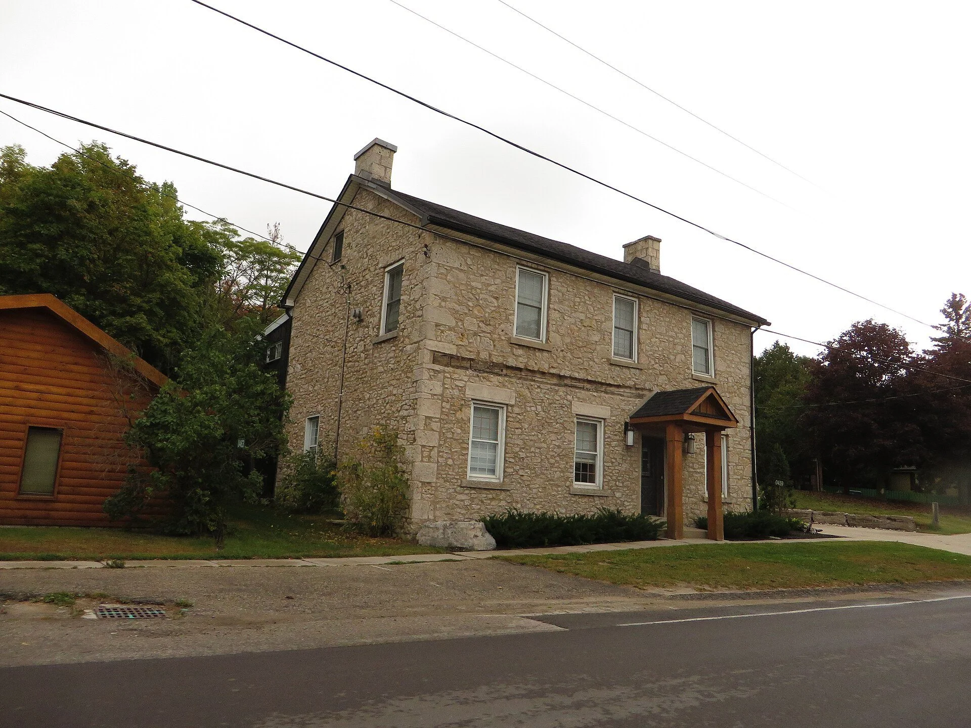 A historic stone house on a quiet street in Elora, Ontario.