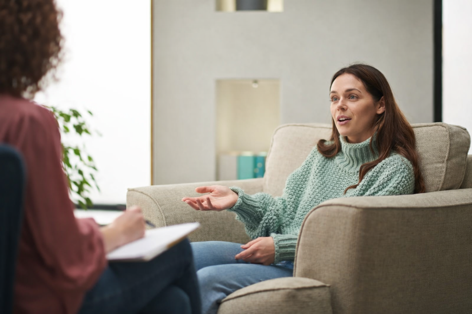 female psychologist with a female client in our cambridge office conducting a psychological assessment for ocd while they both sit on our soft beige couches and talk.png