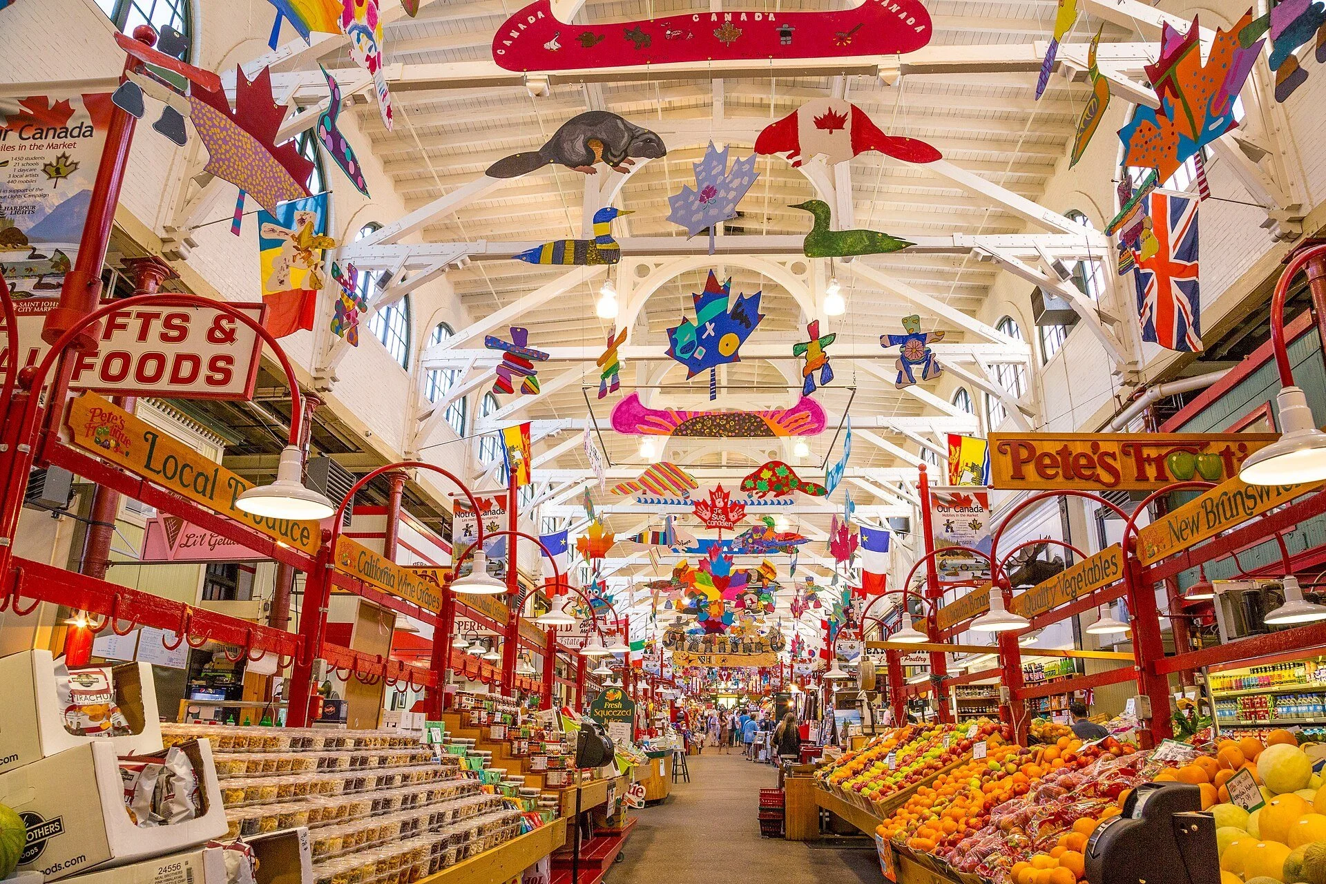 Produce stalls and colourful hanging decorations under the long arched roof of the Saint John City Market in Saint John, New Brunswick.