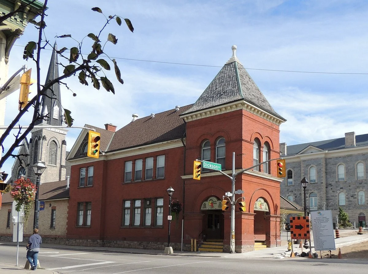 The red brick Cambridge Farmers' Market building with its peaked tower on a sunny day in downtown Galt, Cambridge.