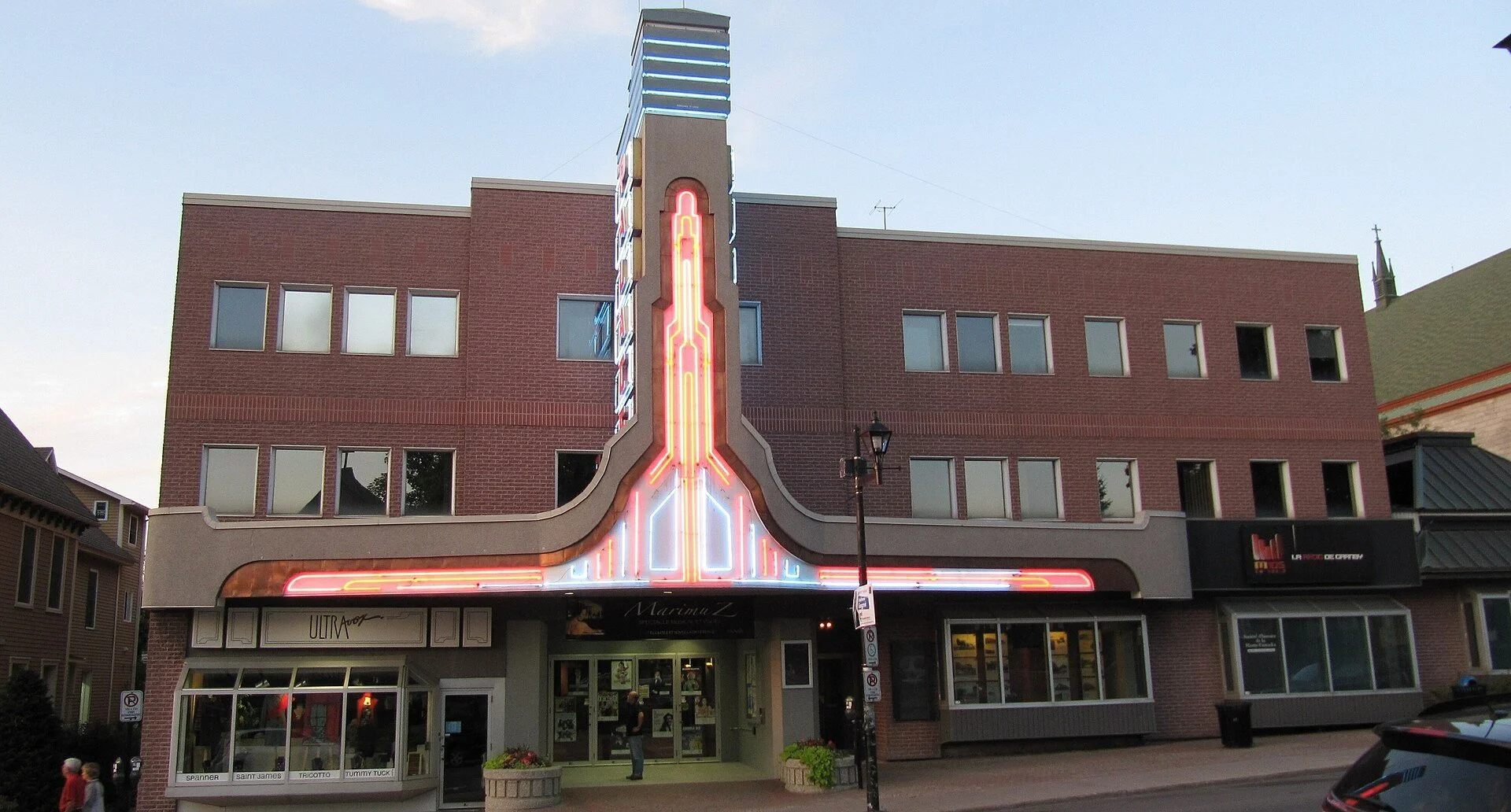 The Palace de Granby theatre with its lit marquee sign on rue Principale in Granby, Quebec.