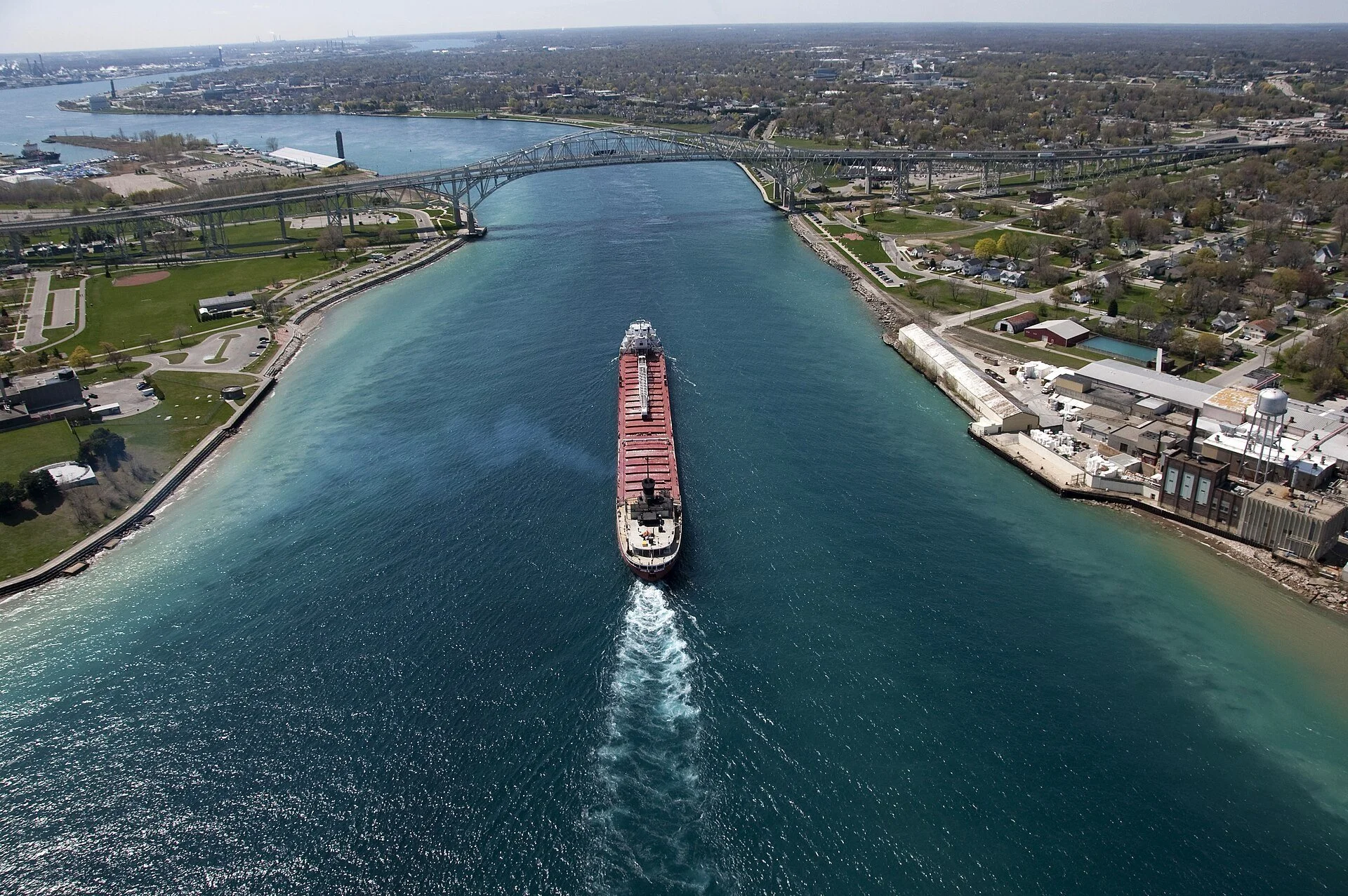 An aerial view of a lake freighter heading down the St. Clair River toward the Blue Water Bridge at Sarnia, Ontario.