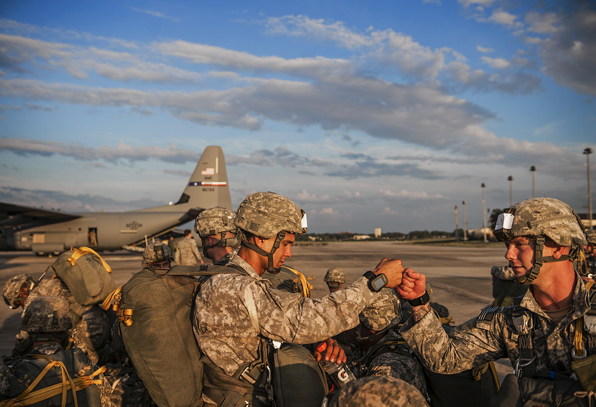 Soldiers of the 82nd Airborne Division bump fists as they prepare for take off during the Emergency Deployment Readiness Exercise on Wednesday, July 15, 2014 at Pope Airfield on Fort Bragg in Fayetteville, N.C. The soldiers have 60 hours before taking flight and parachuting into a training mission at Eglin Air Force Base in Florida. The exercise gives soldiers a chance to hone their skills in case they are needed to jump into a hostile environment or to help provide humanitarian relief.