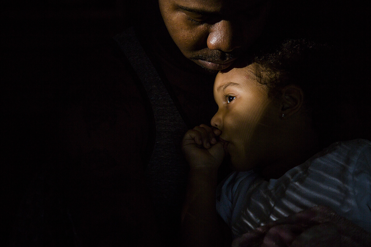 Marques Nash comforts his daughter Demi after a long day of visiting friends and family in Matthews, N.C. on Sunday, May 5, 2015. Nash has an informal custody agreement with Demi's mother which allows them to share the responsibility of caring for her. Fatherhood has given him a new purpose in life outside of his desire to become a musician.