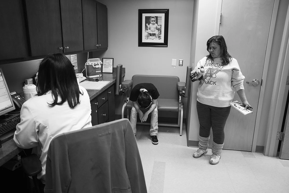  Arielle lowers her head while she waits with her mother, Arque, to finish getting her vitals taken during her WIC renewal appointment. 