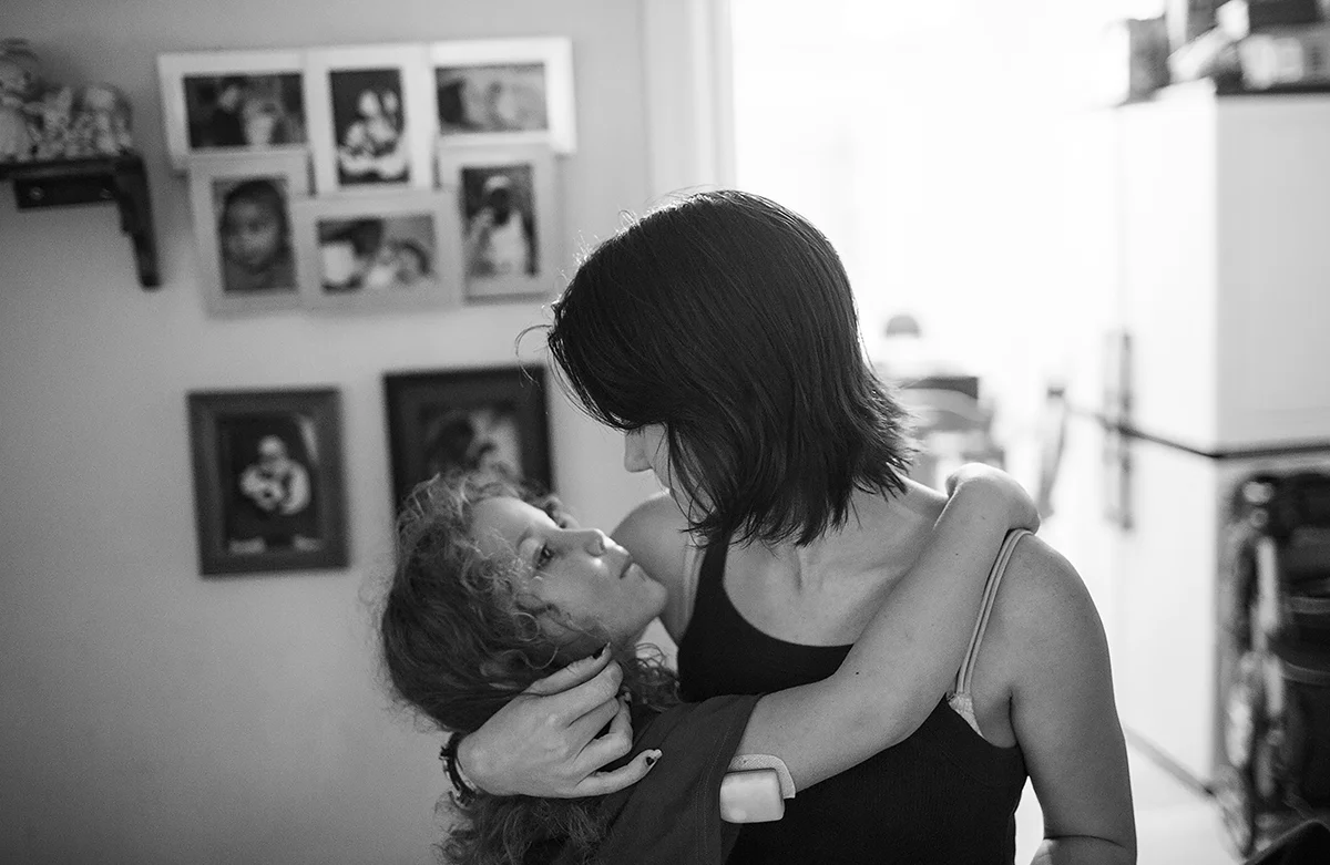  Arielle embraces her daughter Katana, 8, after she gets home from school. Katana was born with type 1 diabetes and wears a insulin pump on her arm. Arielle says that she could not afford Katanas medical bills when she was born and considers it one o